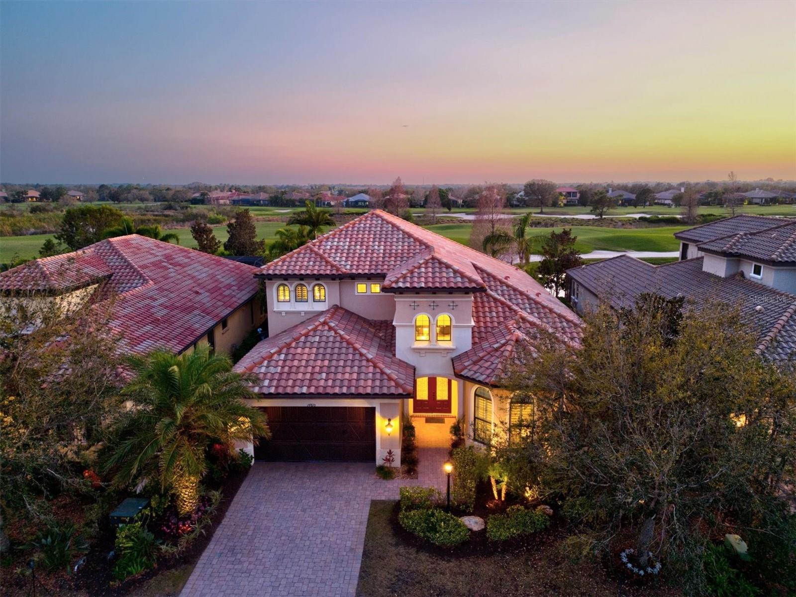 Luxury awaits in this gorgeous Keystone Grand II - Former Model Home - in the prestigious and amenity rich community of Country Club East! If you are looking for the WOW factor, you will get it as soon as you walk through the double front doors and take in the stunning open foyer with high ceilings, custom marble and hardwood flooring throughout, custom wood details including crown molding, wainscoting and designer coffered ceilings! And that view!! Situated perfectly to soak up all that glorious sun with southwestern exposure overlooking the vast greens of the 15th hole, you may never want to leave! With an expansive floor plan and 4000 sf of living space, you will find that this home offers the perfect space to entertain while also allowing for privacy! The main floor features a large master bedroom with fabulous soaking tub, oversized walk-in shower and a dreamy closet, additional bedroom with ensuite, amazing great room and formal dining room, oversized laundry room, office/den space with french doors that can easily be transformed into a 4th bedroom and expansive gourmet kitchen equipped with all GE Monogram appliances, custom hardwood cabinets, granite countertops and Ecowater filtration system. The break away sliders allow for true indoor - outdoor living space as you are greeted by the large brick paved lanai, perfect for watching those cotton candy sky sunsets or for entertaining with its outdoor summer kitchen, gas fire pit, half bath exclusive to the lanai and heated saltwater pool/spa with outdoor shower. Second floor features a third bedroom with ensuite and ample possibilities with a large bonus room, wet bar and french doors that overlook the open patio and golf course. Current owners have spent over 100k in upgrades from landscaping, whole house paint, lighting throughout the entire home, whole house generator, HVAC, pool system and brand new pool pump! Other features include On-Q whole home integrated music system, hurricane impact windows and sliders. The long, extended two car garage allows for storage of two vehicles in addition to a golf cart! The lovely golf community of Country Club East offers a variety of amenities such as 3 community pools with the large heated Retreat pool, a social area with a pool table, bar and outdoor grilling area. The Retreat clubhouse also offers a fitness area featuring the latest work out equipment. Perfectly situated in the heart of Lakewood Ranch, you will find everything you need is right at your fingertips, from premiere shopping and dining, LWR Main St, Waterside, UTC and of course those award winning white sand beaches!
