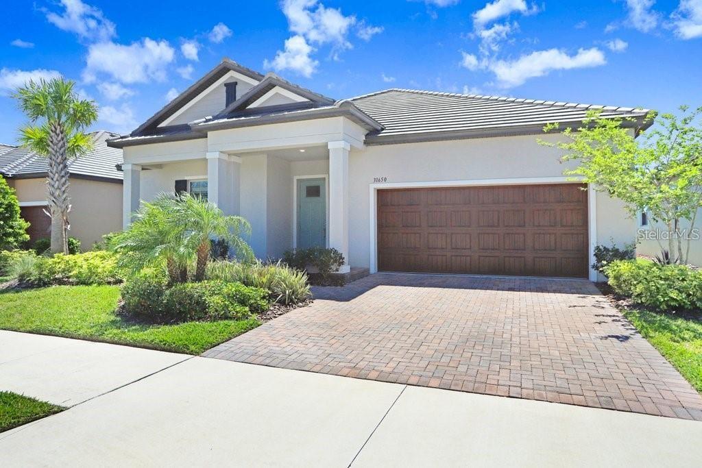 This spacious single-family home in the Crystal Lagoon community of Mirada offers a vibrant 55+ lifestyle in Tampa Bay. Situated in the highly desirable Mirada community. The home boasts a well-designed open layout, with a spacious kitchen featuring quartz countertops, stainless steel appliances, beautiful cabinets, and a large pantry. The living room/dining room combo opens onto a covered screened lanai, ideal for enjoying the Florida weather. The property comprises two bedrooms and two and a half bathrooms. The oversized owner's suite features a generous walk-in closet and an ensuite bathroom with a walk-in shower and double sink vanity. Additionally, there's a guest bedroom with a private bathroom. The home includes a flex room, providing versatile space that can be tailored to suit various needs, such as a home office, hobby room, or additional living area. Residents of the active adult Mirada community have exclusive access to a private resort-style amenity center, which includes a pool, sports courts, and clubhouse. Moreover, the Mirada community features a remarkable 15-acre Crystal Lagoon, surrounded by sandy beaches with cabanas, water slides, a swim-up bar, and more, offering a truly luxurious lifestyle experience. The rental includes Golf Cart, cable and high-speed internet, enhancing convenience and affordability for tenants. It's conveniently located near shopping centers, an outlet mall, hospitals, restaurants, and major highways, facilitating easy travel and commuting. Overall, this home presents an attractive opportunity for those seeking an active adult lifestyle in a thriving community setting. To experience the charm and comfort of this property firsthand, schedule a showing today!