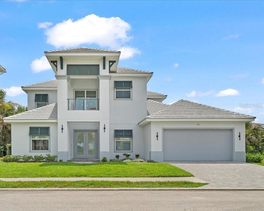 Welcome to 23 Ocean Ridge Boulevard North – a coastal contemporary beachside stunner giving you that new home feel without the wait to build! Nestled on a private lot in the Ocean Ridge neighborhood inside Ocean Hammock, this custom-built and designed home is the perfect combination of luxury while promoting easy coastal living and all the conveniences you desire.  
Stately curb appeal greets you as you enter the home via large double doors. The dramatic two-story entry foyer flows into the light and airy open concept first floor. A lower-level bedroom currently used as an office space provides direct access to a full bathroom, giving flexibility as work or bedroom space. A formal dining room flanks the entry foyer with plenty of seating for 10+ in an intimate setting, overlooking the lush street landscaping through large windows. The main living area provides ample seating space for your large group. This space can easily divided into dual seating areas to enhance entertaining, and complete with a large collapsible slider to the screened lanai. A highlight of this space is the floor to ceiling stone linear fireplace, providing lovely ambience for relaxation.  The adjacent kitchen features 42-inch cabinetry, quartz countertops, glass tile backsplash, walk-in pantry and separate breakfast nook, overlooking the sparkling pool and spa.  A first-floor primary suite features a large bay window overlooking the pool, tray ceiling, soaking tub, large walk-through shower, double sink vanity with lighted LED mirrors and seated vanity space, and walk-in closet with custom closet system. Rounding out this well-designed lower level is a laundry room with extra storage.
Heading up the hardwood staircase, you are greeted by a large loft space.  Currently used as a home gym, the options are limitless of this space! After your workout, open up the stackable sliding door and cool off on your back screened balcony with a view of the 6th fairway of the world-renowned Ocean Course of The Club at Hammock Beach. Want a relaxing but entertaining night in?  Head to the tiered media room with surround sound and kick up your feet for a great movie or some karaoke – but don’t forget to grab some popcorn and snacks at the mini-bar on your way in!  A special treat off the media room is floored attic storage! 3 spacious bedrooms and 2 full baths complete the upstairs living area of this home.
Outdoors, you are greeted by the lush Florida landscaping on this preserve lot. A custom-designed screened and heated pool and spa provides great fun and relaxation for the whole family, while being steps from the north walkover for direct beach access.  
Have a few vehicles? Don’t let the 2-car garage door fool you! This home boasts a 3 car tandem garage that is already pre-wired for two additional vehicle lifts – perfect for the car aficionado! This garage is spotless with a upgraded lighting, finished floor and workshop space for your projects!
In addition to the amenities provided by this property, enjoy the safety and security of the gated Ocean Hammock community. Additionally, optional beach club and full golf memberships are available for purchase at The Club at Hammock Beach! Easy access to area restaurants, medical and shopping. With easy access to Orlando, Jacksonville and Daytona Beach airports, travel to and from the area is a breeze. Don’t miss this fantastic opportunity in one of the area’s most desired communities!