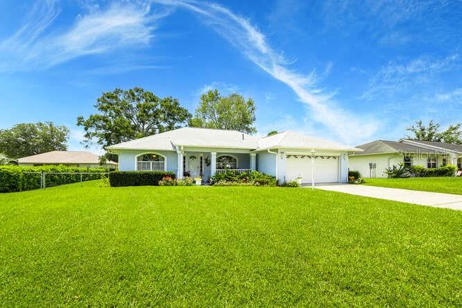Welcome to this beautifully maintained, custom-built home by Murphy Kaufman Builders. This 2-bedroom 2-bathroom residence offers an inviting open floor plan with high ceilings, creating a spacious and comfortable flow throughout the main living areas. You're welcomed by a charming front porch with two rocking chairs and a peaceful spot to relax and enjoy the quiet neighborhood. As a special gesture, the rocking chairs will come with the house for the new owners to enjoy. Inside, the kitchen features ceramic tile floors, a brand-new dishwasher, updated appliances, and quartz countertops. It also includes a nice bar area perfect for casual seating. This kitchen features windows that overlook the backyard, allowing plenty of natural light and offering a peaceful view while you cook and entertain. The bedrooms all feature freshly cleaned carpets for a move-in-ready feel. The primary bath features a step-in shower with handrails and a walk-in closet. The laundry room is located inside the home, adding ease and functionality to your daily routine. This home also features a 2-car garage complete with a roll-down retractable screen door. The back porch is equally inviting, featuring modern-style windows and a ceiling fan that creates a bright, inviting space. This enclosed area is a true multipurpose room that could be easily used as a bonus room, home office, or even an extra bedroom. The water heater is two (2) years old, and the roof is three (3) years old. Step out onto the newly installed pavers that lead you into the well-maintained backyard filled with beautiful flowers. It's a bird lover's paradise, as the previous owner regularly fed the birds, and they still return to visit. This home also comes equipped with a water softener system and a water purification system. Across the street, a clubhouse with a pool offers easy access to recreation and relaxation. This move-in-ready, turn-key home provides comfort and convenience, located just minutes from grocery stores, dining, and shopping, as well as downtown Ocala.