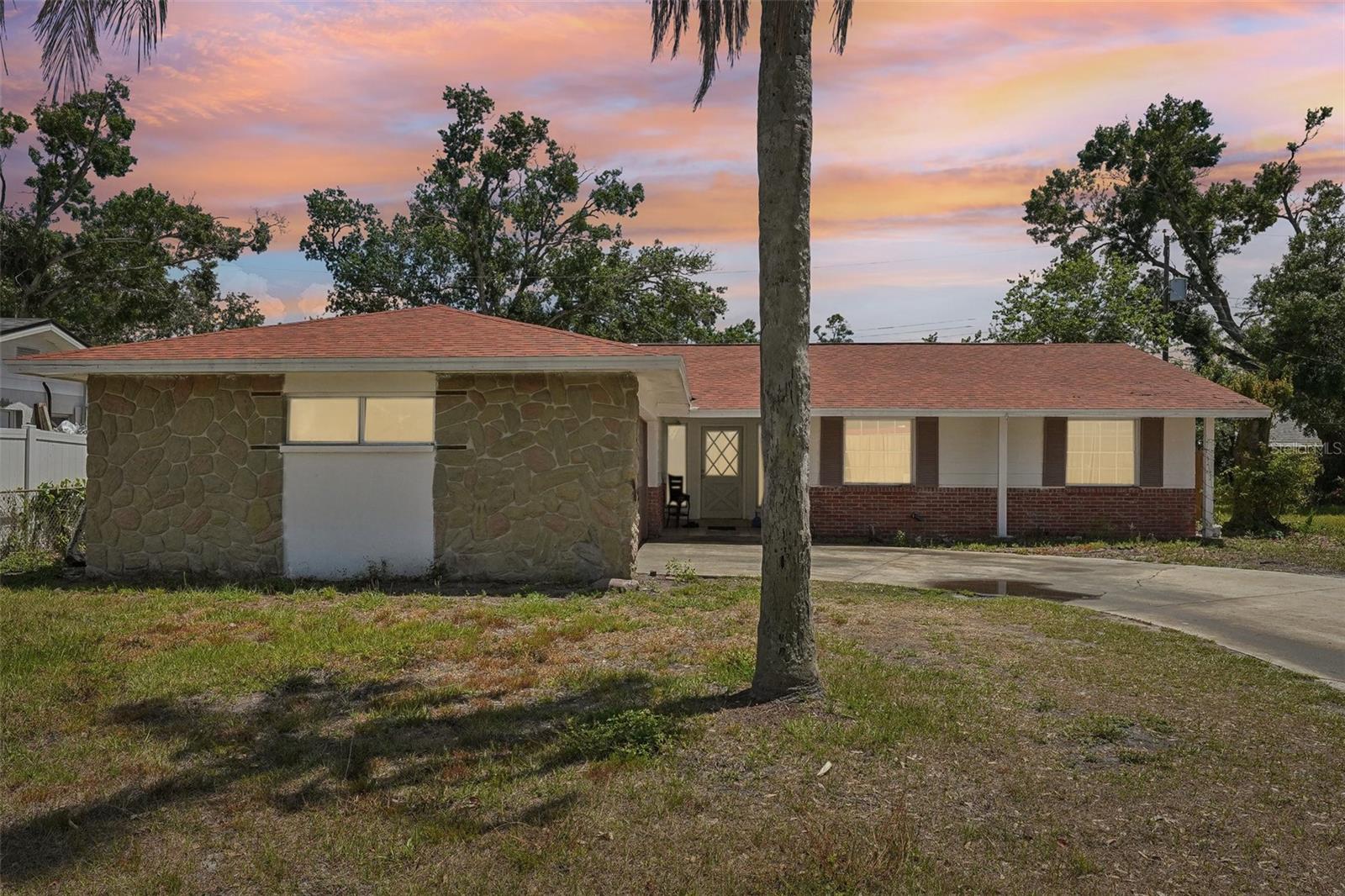 Discover the potential in this spacious 4-bedroom, 2-bathroom home with no HOA, offering flexibility and room to grow. Currently configured with six rooms, it offers a fantastic opportunity for a pad split with just a bit of updating. The kitchen features a convenient breakfast bar, abundant cabinet space, and flows into an area ideal for additional dining. The large living area provides plenty of room for gathering and relaxing. The primary bedroom includes an ensuite bathroom with a walk-in shower. Three additional bedrooms offer versatility, including two without closets—perfect for guest rooms, home offices, or hobby spaces. A second full bathroom serves the rest of the home. Enjoy outdoor living in the generously sized screened lanai, which leads to a fully fenced backyard—ideal for pets, play, or future outdoor enhancements. Whether you're looking for multi-generational living or extra room for work and leisure, this property offers space and freedom with no community restrictions.