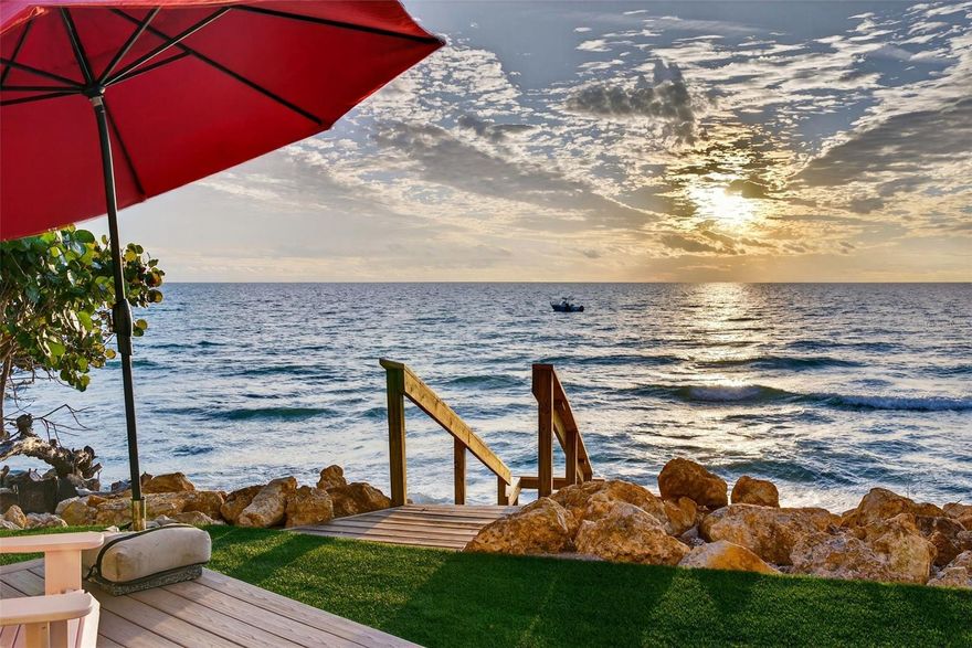 Commanding a dramatic Gulf-front position atop Point of Rocks, this extraordinary coastal compound offers a front-row seat to sweeping 180° panoramic views and unforgettable sunsets over the Gulf of Mexico. Built to the highest Florida Green Building Coalition standards, this home is majestically poised 14.2' above sea level to appreciate rolling waves gently lapping against the rocks and sandy shoreline below. Quintessential Old Florida charm defines this rare offering, featuring a 4-bedroom main residence and a separate 2-bedroom guest cottage, all set on beautifully landscaped, gated grounds. The main home showcases wall-to-wall, floor-to-ceiling windows and sliders overlooking the Gulf, filling the interiors with natural light. The living room features a striking tiered ceiling, recessed lighting, a new wood-burning fireplace with a shiplap accent wall, custom built-in bookcases, and electronic shades. Hardwood floors run throughout. The light-filled kitchen offers stunning Gulf views and features a large custom-built island with breakfast bar and second sink, quartz countertops, artistic tile backsplash, pendant lighting, a 5-burner induction cooktop, KitchenAid dishwasher, and built-in stacked microwave and convection oven with warming drawers. The dining area boasts extraordinary Gulf views. Two ensuite guest bedrooms, a powder bath with wood-paneled wainscoting, and a laundry room with built-in cabinetry and utility sink conveniently located off the kitchen completes the first level. The primary suite on the second level is a true retreat with breathtaking Gulf views, a tiered ceiling with fans, a sitting area, and access to a screened terrace. The spa-like bath features dual walk-in closets, freestanding tub with Gulf views, dual vanities, walk-in shower, and tile floors. The additional second-floor bedroom boasts wood floors, built-in bookcases, a deck, and full bath, making it an ideal office space or hobby room as well. Outdoor amenities include a heated saltwater pool with swim-up seating and custom waterfall feature, mature tropical landscaping, hurricane-rated windows and doors, a 2-car garage with storage, and gated entry. A beautiful promenade overlooking the gulf includes a deck, lush care-free turf, and stairs to the shimmering waters and tide pools unique to this area of Sarasota beachfront. The charming guest cottage offers a living room, full kitchen with bar seating, small dining area, laundry, two bedrooms, and one full bath—ideal for hosting guests or extended family. Recent improvements include full interior and exterior repainting of both the main house and cottage, new en-suite bath added to a first-level guest bedroom, custom floor-to-ceiling bookcases in the living room and upstairs Gulf-side guest suite, two new AC systems, motorized screens on the upper terrace, a new outdoor deck with filled walk-over beach stairs, and a metal roof installed on the cottage in 2021. A rare Gulf-front opportunity combining privacy, character, and panoramic coastal beauty all within minutes of dining, shops, and the mainland. The shelling and wade fishing right outside your door is the icing on the cake!