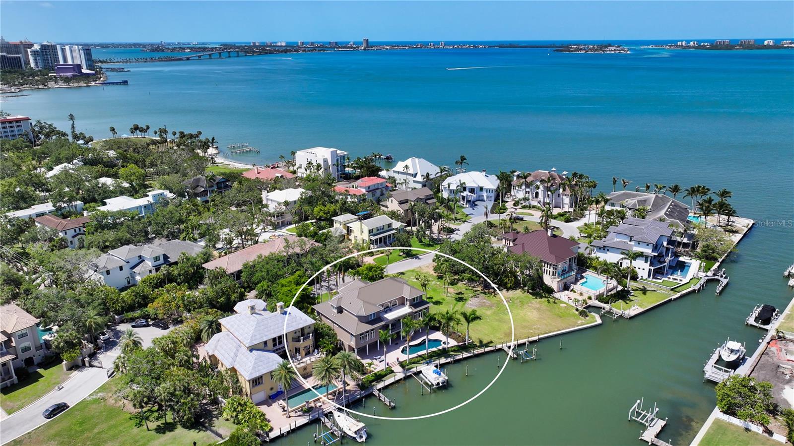 Waterfront Estate in the gated community of Whitakers Landing, less than a mile to Downtown Sarasota. Nestled on the serene waters of Whitaker Bayou with direct access to Sarasota Bay, this exquisite estate blends timeless design with modern luxury. Built in 2006 and immaculately cared for, the home features a Brand-New Metal Roof and 7,233 square feet of beautifully crafted interior space with high-end finishes throughout. Almost every room opens to a tiled terrace, maximizing indoor-outdoor living and capturing tranquil water views. The expansive living and dining room impress with soaring cathedral ceilings and a dramatic second-level wraparound promenade, creating a grand and open setting for entertaining. The gourmet kitchen is thoughtfully designed with custom cabinetry, high-end appliances, breakfast bar and a wine bar. It flows seamlessly into a spacious family room and casual dining area framed by walls of windows and French doors to the terrace. The first-floor primary suite offers ultimate privacy and relaxation with wood floors, two generous closets, a spa-inspired marble bathroom, and access to two private terraces and nearby office. Upstairs, four large guest suites, two with private ensuite bathrooms, provide ample space and privacy. Located in the exclusive gated enclave of Whitakers Landing, this residence includes private boat dockage and is just moments from the cultural and dining attractions of downtown Sarasota. A house so grand, even the laundry room has its own terrace....call to schedule your showing today—before someone else beats you to it.