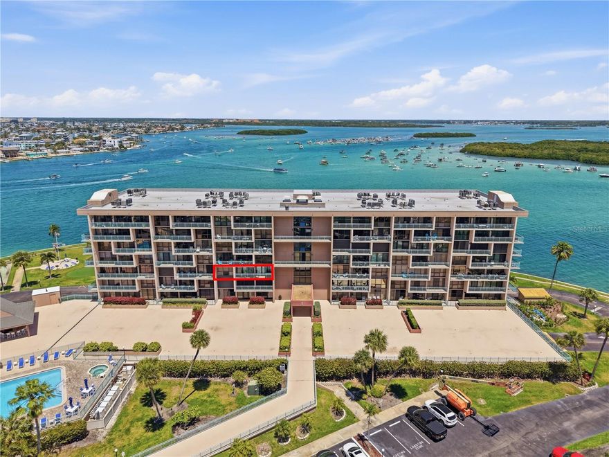 Experience the ultimate “private island” lifestyle in this meticulously renovated gated condominium. Highlighting Sweeping Southwest views of the Marina and the Gulf of Mexico, this residence features a creative floor plan that breaks traditional constraints.  The versatile bonus room is perfect for a home office or a guest suite with the addition of a Murphy bed. The chef-inspired kitchen is a showpiece, boasting quartz countertops and custom Forevermark Cabinetry with soft-close hardware. Premium tile flooring flows seamlessly throughout the entire unit, leading to a unique dining area complete with custom built-ins cabinets, a wine cooler and a quartz dining table with integrated electrical outlets. The owners retreat offers a spa-like experience with a zero-entry walk in shower, double sinks, quartz countertop, walk-in closet, and extensive built-in storage. Practical luxury meets peace of mind with upgraded electrical panel, and hurricane windows featuring privacy panels. Key Capri offers an unparalleled amenity package, including a geo-thermally climate-controlled pool, an on-site marina, many call Key Capri a boaters paradise, with some of the best slip rates and a half-mile waterfront walking path, fishing pier, kayak launch, fitness center, BBQ area, pickle ball/tennis, billiards, social room, putting green complete with covered parking and a private storage shed.  This is more than a home---it is a LIFESTYLE