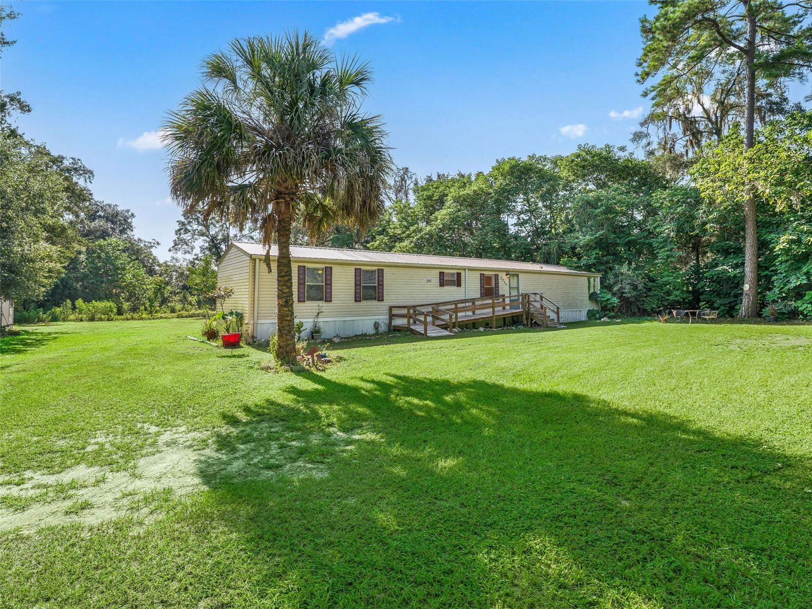 Great Location – Spacious Lot – Move-In Ready! Don’t miss this opportunity to own a well-maintained 3 bedroom, 2 bath manufactured home on a generous 1.19-acre A1-zoned lot! The property backs up to a picturesque 70-acre pasture, offering privacy and beautiful views. With ample space, there’s plenty of room to build an additional home or expand. Ideally located just minutes from I-75 for quick access to Ocala or Gainesville, and close to the World Equestrian Center, shopping, hospitals, and dining. This home features an open-concept layout with a split bedroom floor plan, offering both functionality and privacy. Recent updates include a new metal roof and a new front entry ramp for easy accessibility. Enjoy fresh well water and a septic system, meaning no monthly water bills! Whether you're looking for peaceful country living or an investment opportunity, this property has it all!