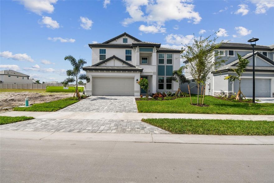 Discover the Estero model in Hawkstone, a beautifully designed 5-bedroom, 4-bathroom, two-story home offering approximately 3,300 square feet of thoughtfully planned living space. This new construction home features a desirable open-concept floor plan with a spacious great room that seamlessly connects to the café and gourmet kitchen, complete with a large center island, walk-in pantry, and abundant cabinetry. Upon entry, the welcoming foyer is flanked by a versatile flex room/home office and convenient laundry room. The first floor also includes a private guest bedroom with access to a full bath, ideal for visitors. Sliding glass doors lead to a covered lanai, creating effortless indoor-outdoor living and room to enjoy the Florida lifestyle. Upstairs, the expansive primary suite offers a true retreat with dual walk-in closets, dual vanities, and a spacious shower. Additional bedrooms are well-positioned for comfort and privacy, while the large bonus room/loft provides flexible space for a media room, playroom, fitness area, or additional living area. Designed with both function and style in mind, this home offers ample storage, flexible living spaces, and modern finishes throughout. Located in sought-after Hawkstone in Sarasota, this property presents an exceptional opportunity to own a move-in ready new home near shopping, dining, top-rated amenities, and major commuter routes. ****SPECIAL FINANCING AVAILABLE FOR A LIMITED TIME ONLY FROM PREFERRED LENDER. RESTRICTIONS APPLY, FOR QUALIFIED BUYERS, SUBJECT TO APPLICABLE TERMS AND CONDITIONS. SUBJECT TO CHANGE WITHOUT NOTICE****