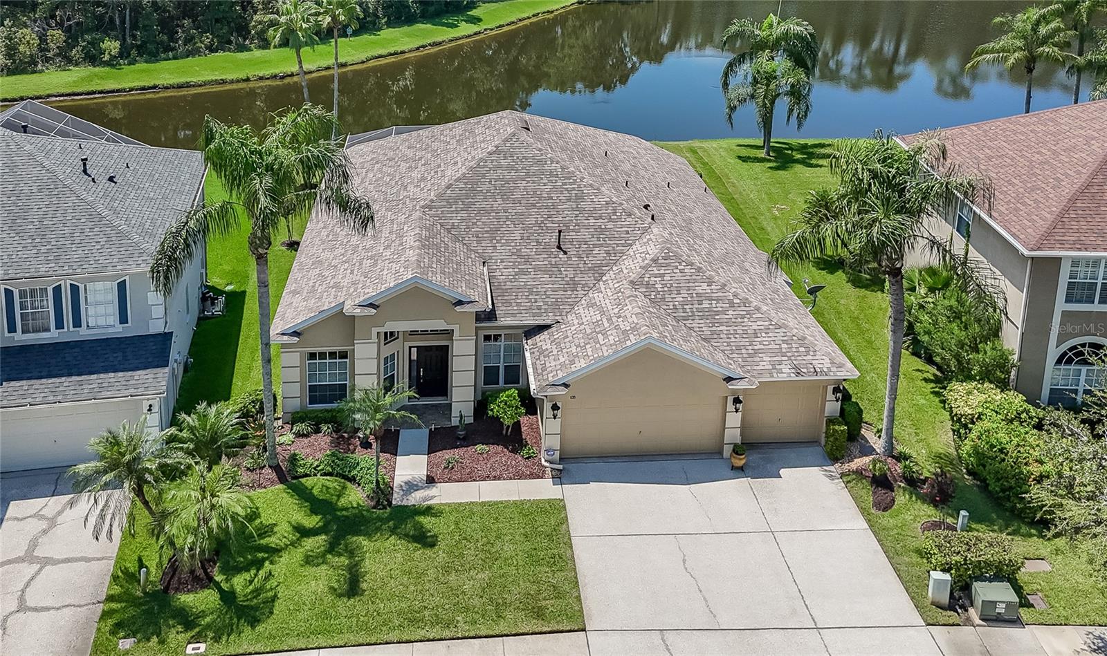 A rare opportunity awaits! This spectacular 4-bedroom, 2.5-bath pool home with a heated spa sits on one of the most incredible pond and conservation lots you will ever find - offering breathtaking views, total serenity, and nature right in your own backyard. From the moment you step through the front door, your eyes are drawn straight through the home to the sparkling pool and peaceful water view beyond. This is truly a setting that must be experienced to be believed. Not only does this home have a showstopping backdrop, it also comes with a highly desirable 3-car garage - the perfect space for multiple vehicles, a workshop, or extra storage. Inside, soaring 12-foot ceilings, neutral colors, and engineered hardwood floors in the living, dining, and family rooms create a warm and spacious atmosphere. The oversized lanai is ideal for Florida living, with plenty of room for dining tables, couches, and lounge chairs so you can entertain or simply relax poolside while soaking in the view. The well-designed floor plan includes a kitchen that overlooks the family room, complete with a breakfast bar and pantry. The fourth bedroom, featuring two closets, is currently being used as an office, while the conveniently placed half bath just off the lanai is perfect for guests. Every bedroom includes a ceiling fan, and all bathrooms have been beautifully updated. The primary suite offers private pool and pond views, along with an ensuite bath featuring quartz countertops, two separated vanities, a spacious tiled shower, and an exceptionally large walk-in closet offering both function and luxury. Adding to the appeal of this home is the peace of mind that comes with so many big-ticket updates already done for you: the roof (2020), hot water heater (2025), and AC system (2017) provide security and efficiency for years to come. The washer (2025) and dryer (2017) are included, and the kitchen has a newer stove (2022) and refrigerator (2021). With these major items already taken care of, you can simply move in and enjoy your home without the worry or expense of costly replacements. The location is just as impressive as the home itself - you don't even need a car, with major shopping just two blocks away. You'll also have quick access to major roads, restaurants, hospitals, and the popular Wiregrass Mall. Best of all, there's no CDD and a low HOA of only $750 a year, which includes access to community amenities such as a playground with gazebo and a tennis/pickleball court. This one-of-a-kind property combines the ultimate in privacy, comfort, and convenience - but opportunities like this don't come along often. Don't wait - seize the moment before it passes you by!