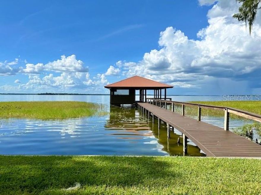 9-acre LAKEFRONT DREAM HOME ON LAKE GRIFFIN with NEW CUSTOM SCREENED IN $250K BOATHOUSE with high-end kitchen and grill! Plus bonus WORKSHOP/fish house with garage on the property. This beautiful 3 bedroom 3.5 bath home offers 3,200 sqft. The property stands majestically on an expansive 9-acre lot with a vast lawn that gently slops towards the pristine shores of Lake Griffin. The architecture of the house perfectly captures the essence of LAKESIDE LIVING,  with large sliding doors/ windows that provide breathtaking views of the shimmering waters and draw in an abundance of natural light. Lake Griffin is one of the most pristine lakes amount he CHAIN OF LAKES in Florida. the beautiful body of water stretches over 9,400 acres and offers a serene and picturesque setting for water enthusiast and nature lovers alike. As you walk inside, the hardwood floors in the foyer exude warmth and elegance, seamlessly blending with the soothing color palette that mirrors the tranquil blues and greens of the lake.The FRENCH DOORS will bring you to the living area. The OPEN-CONCEPT all-tile layout enhances the flow of the home, creating a sense of cohesion between the living area with gas FIREPLACE, Formal dining room, and spacious gourmet kitchen, equipped with top-of-the-line STAINLESS STEEL appliances, wood cabinets, GRANITE COUNTERS, and a large bar. It was evident that no expense was spared in creating a space that combines functionality and beauty for even the most discerning culinary enthusiast. Right next to the kitchen, you will find a 9 X 32 SUNROOM which is a perfect space for entertaining along with a recently renovated hallway with a BAR. The primary bedroom off the foyer exudes relaxation and comfort. Large WALK-in CLOSET. The windows provide panoramic views of the lake, while the en-suite bathroom boasts a spa-like atmosphere complete with a deep soaking TUB, DUAL vanities, and a separate shower. All Bedrooms have their own private bathroom. An Extra 4th bedroom can be built upstairs in the unfinished ATTIC Space. Beautiful SCREENED In 47 X 14 LANAI where you can enjoy entertaining family and friends or relaxing on the lounge chairs looking at the incredible picturesque backyard with lakefront views. The Owners went all out in making this the perfect lake house by adding a $250k custom BOAT DOCK with jet sky launch and SCREENED in KITCHEN with BBQ GRILL, SINK, and FRIDGE. A BREATHTAKING LOUNGE area to enjoy the SUNSET and incredible view of the LAKE. Take your boat out and enjoy BASS fishing or boating around the chain of lakes, visiting Mt Dora and surrounding areas. The home has a 2 car carport but there is an additional detached garage/FISH HOUSE WORKSHOP along with a covered 3 carport for extra vehicles/trailers for a total of 6 spaces. This waterfront home on Lake Griffin is truly a gem in the Chain of Lakes. Its elevated design, attention to detail, and luxurious amenities make it an ideal retreat for those seeking a truly exceptional lakeside living experience with NO HOA. It was apparent that the owners had masterfully curated this space, ensuring that every waking moment in this luxury haven was one of serenity and rejuvenation. There are 3 parcels included in this sale and can be split if desired. This property is currently a very sucessful short term rental.