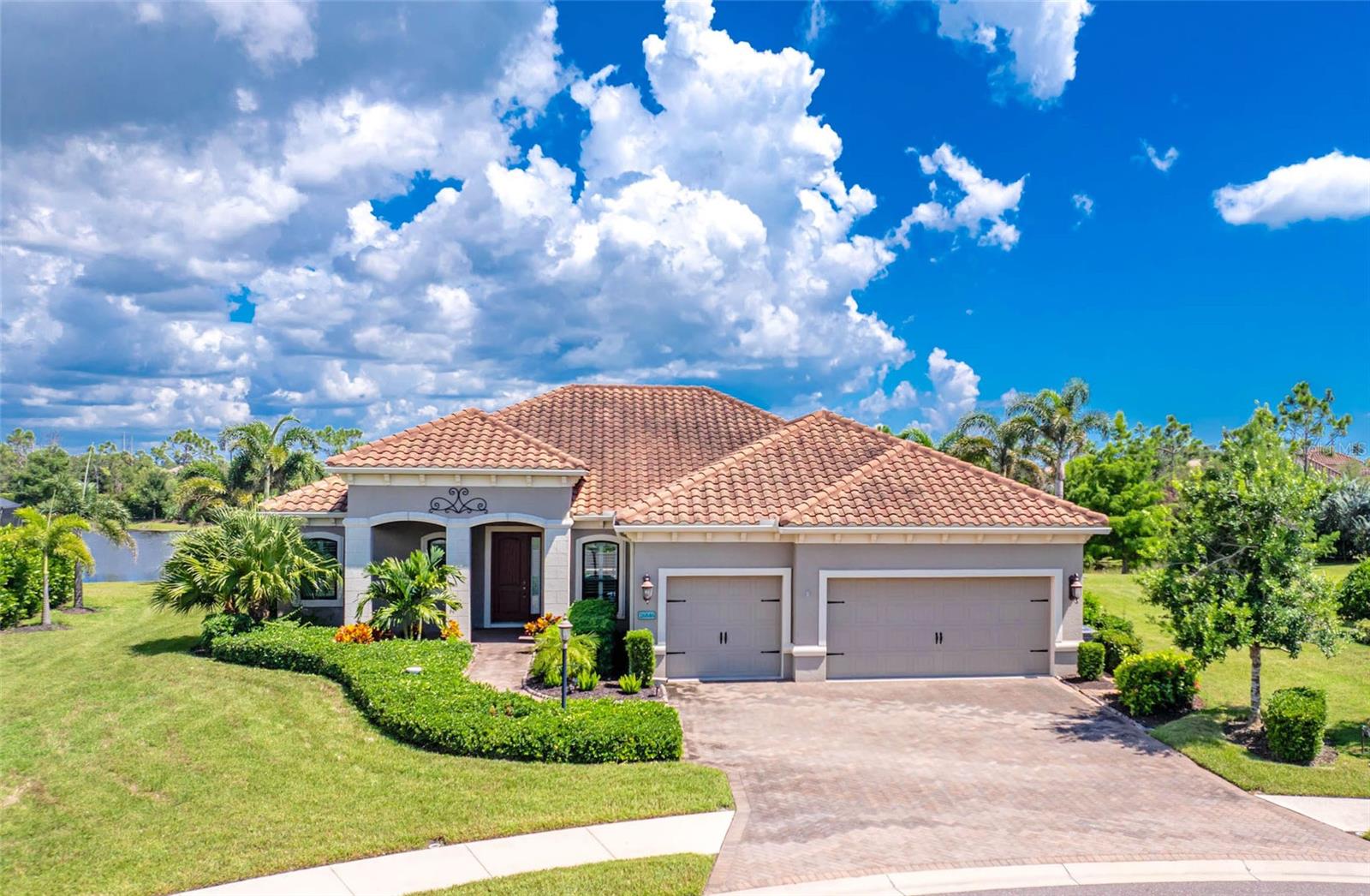 This is the house you have been waiting for in Boca Royale! Built in 2016, this exquisite Sanibel model offers a split floor plan with an open concept living area, high ceilings, crown molding and tile floors throughout the main living areas. Add to your culinary adventures with ease in your chef kitchen that includes upgraded stainless steel appliances; gas cooktop, built-in double oven with convection, range hood that vents outside and upgraded cabinets, elegant granite countertops and stylish tile backsplash. Steps away, enjoy your perfectly prepared meal in your oversized dining room open to the Great Room, overlooking the lanai. Sliding glass doors lead out to the covered, screened lanai perfect for enjoying the sunrise. Spend quality time soaking up the sun with family and friends in your custom designed saltwater pool complete with a heater and sun shelf, backing up to mature landscaping with a water view. A full pool bath, with enclosed glass shower, accessible from the lanai is steps away. The spacious master suite, situated towards the back of your home, provides maximized peace and privacy. Double master closets provide easy storage for all your warm weather clothing. The spa-like master bath is adored with an oversized walk-in shower, a relaxing garden tub, dual vanities and a private toilet room. Guests can enjoy their stay in one of two bedrooms located in the guest wing with the second bathroom between. Need a little more space? The oversized, french door, enclosed Club Room has many useful options with a sliding glass door leading out to the covered lanai. Make it your home office, a quiet sitting room or can double as an extra bedroom. This Sanibel offers a 3 car garage, with plenty of room to house your vehicles and golf cart with additional space for storage. This house is complete with Kevlar slide-in hurricane window covers and Storm Smart Shutters that roll down enclosing the covered lanai! Take advantage of the resort style pools located around the corner from your new home. Participate in diverse social gathering and activities, play pickleball, tennis and golf or utilize the fitness center to stay in shape. Humans are not the only ones with amenities. The pups have their own dog park! The main clubhouse offers lunch and dinner dining options inside and out as well as a beautifully renovated bar. Want to enjoy the Gulf beaches? There are five public beaches within 20 minutes. Discover Historic Dearborn Street for shopping, diverse dining and weekly farmers market for fresh produce, seafood and local art. Come live the Florida dream. Schedule your showing today!