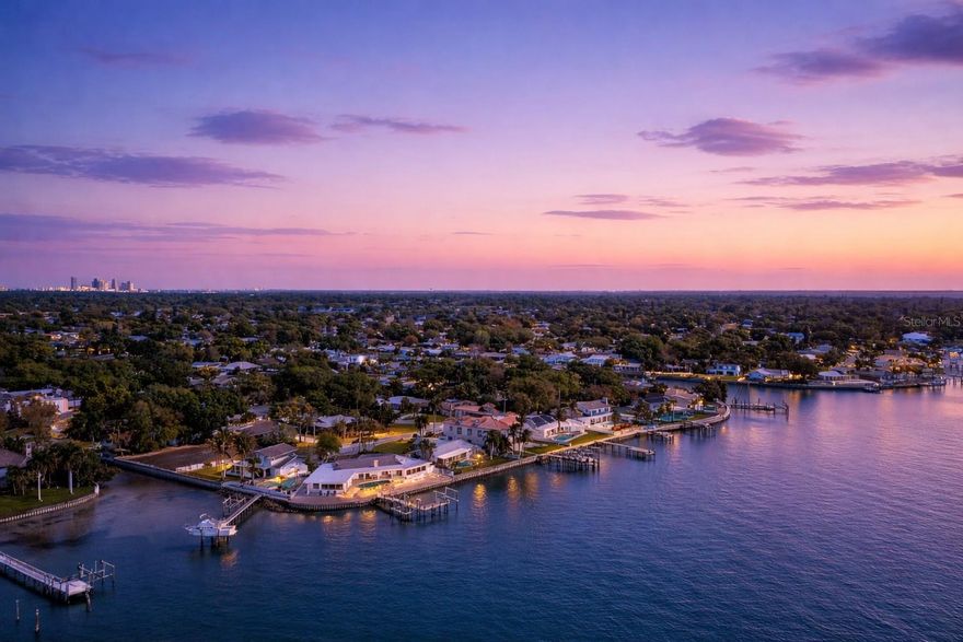 Perfectly positioned to capture the best of both worlds, this exceptional waterfront estate offers a rare blend of serene coastal living and effortless access to vibrant city life. Ideally located just minutes from downtown, award-winning Gulf beaches, premier shopping, and an array of top-tier restaurants, this residence delivers the ultimate Florida lifestyle.
Set on deep, protected water with direct Gulf access, this property is a dream for boating enthusiasts—yet equally appealing for those who value convenience, culture, and connection. Spend your mornings on the water, afternoons exploring boutique shops or waterfront cafés, and evenings enjoying the energy of downtown just moments away.
Designed with both elegance and resilience in mind, the home has remained high and dry through past hurricanes, offering exceptional peace of mind in a premier waterfront setting.
A true boater’s sanctuary, the private dock features a double lift accommodating vessels up to 26’ and 38’, along with an impressive low-tide depth of approximately 6 feet—ideal for larger boats. With quick, easy access to open Gulf waters, every day invites a new adventure.
Inside, the home offers a seamless single-story layout with breathtaking water views from nearly every room, creating the feeling of living directly on the water. The gourmet kitchen is a chef’s dream, appointed with top-of-the-line Viking appliances and a cooktop perfectly positioned to overlook the tranquil waterfront.
Outdoor living is equally captivating, featuring a 170-foot seawall lined with elegant, cool-to-the-touch brick pavers, a sparkling pool, and expansive areas designed for both relaxation and entertaining. Enjoy fishing from your dock, watching dolphins and manatees glide by, or simply taking in the serene beauty of your surroundings.
This beautifully appointed residence offers 4 bedrooms and 3.5 bathrooms, complemented by a spacious 2-car garage, a Tesla charging station, a cozy fireplace, and a private dog run—thoughtfully designed to blend comfort, convenience, and modern luxury.
With approximately 180 feet of open water frontage, the property showcases breathtaking panoramic views, including a direct sightline to the iconic Sunshine Skyway Bridge. What makes this home truly extraordinary is the rare combination of deep-water boating capability and its unbeatable proximity to downtown, world-class beaches, shopping, and exceptional dining—creating a lifestyle that is as effortless as it is luxurious.