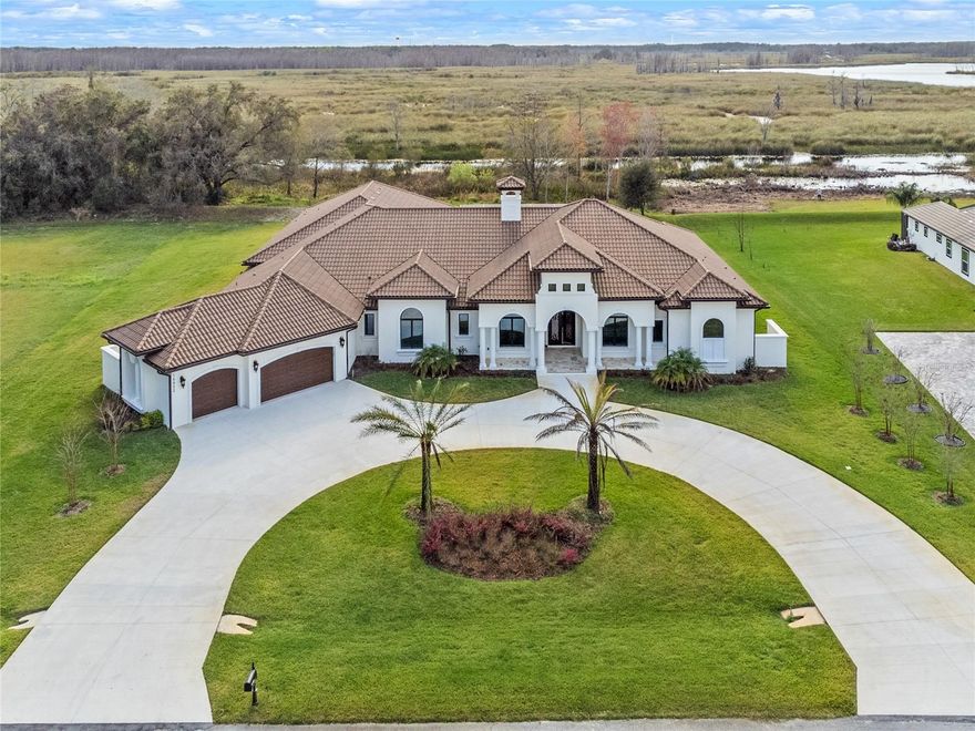 This Amazing, One-of-A-Kind, Custom-Built Home boasts one of the best and largest homes in the prestigious gated community of Garden City. Upon entering the home, you will be greeted by an open living room with soaring ceilings, and a stunning view of lake Stewart, oversized custom pool with large heated spa and steam room that challenges any resort, spectacular outdoor kitchen, bar and entertainment area featuring 2 separate sitting sectors, within the screened enclosure there is plenty of both covered and open patio space along with a large outdoor kitchen for entertaining. With 5 bedrooms and 6 and a halve baths, there is plenty of room for everyone, the oversized master bedroom features hardwood floors, tray ceilings, crown molding, and more. French doors open to the pool area. The on-suite bathroom features a large, jetted tub, a dual entry walk in shower with multiple shower heads, 2 private water closet, spacious dual vanities, along with his & her walk-in closets. This spacious home has a magnificent family room that offers expansive views of the outdoor amenities, the family room boasts coffered ceilings and rope lightning, there is a corner glass wall of doors that completely opens connecting indoors with outdoors, in the most amazing way. This is the view where the pool, the lake, and the life, all come together. The kitchen is a chef's dream come true. It features a central island, loads of counter and cabinet space, upgraded appliances, backsplashes and a step-in pantry. This custom-built home also provides an office, full wet bar, laundry room, 3 car garage with an oversize semicircular driveway, 16 cameras security system, 12 zones audio system with intercom, central vacuum system, generator and more. In addition, you will find that this conveniently located gated community is approximately 45 minutes to Orlando International Airport, Walt Disney World, Restaurants, Hospitals and the Florida’s Turnpike.