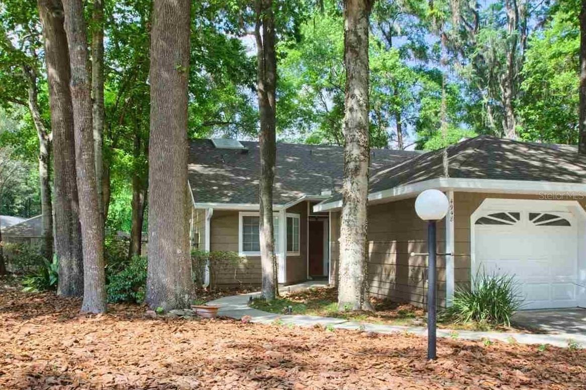 A beautiful townhome in the stunning community of Vintage View! MOTIVATED SELLER! This community is quiet and feels like an oasis while still being centrally located in the Gainesville area. Walking distance to the Oaks Mall. The HOA does all the exterior work and landscaping for you, so you have one less thing to worry about! This property has vaulted ceilings, an inviting fireplace, stainless steel appliances, a spacious master bedroom and bathroom, and natural sky lights. As you enter the unit, you will go through the walkway and see the spacious kitchen, with ample counter space and breakfast nook to your right. As you continue into the home, you will notice the lovely open floor plan design with a study area/flex space looking out of the large arched window. The dining area has a gorgeous stained glass ceiling light and overlooks the living space-complete with a wood-burning fireplace and skylight! Off the back of the home, there are sliding glass doors that leads to the screened in patio that overlooks part of the wooded area and is just a few steps away from the tennis/basketball court. The master bedroom is very spacious and has a large walk-in-closet and vanity. The guest bedroom has a beautiful bay window that would be perfect for curling up under while reading a good book. This unit includes a 1 car garage, with an additional 1 car parking space in the driveway. This unit is so conveniently located in the complex and is just steps from the guest parking spaces, clubhouse, community pool, community garden, and tennis/basketball court. With this property's prime location and its proximity to The Oaks Mall, North Florida Hospital, Santa Fe College, Butler Plaza AND public bus route, this home ideal for a family or graduate student looking for some peace and quiet. You don't want to miss out on this gem! Schedule a showing, today!