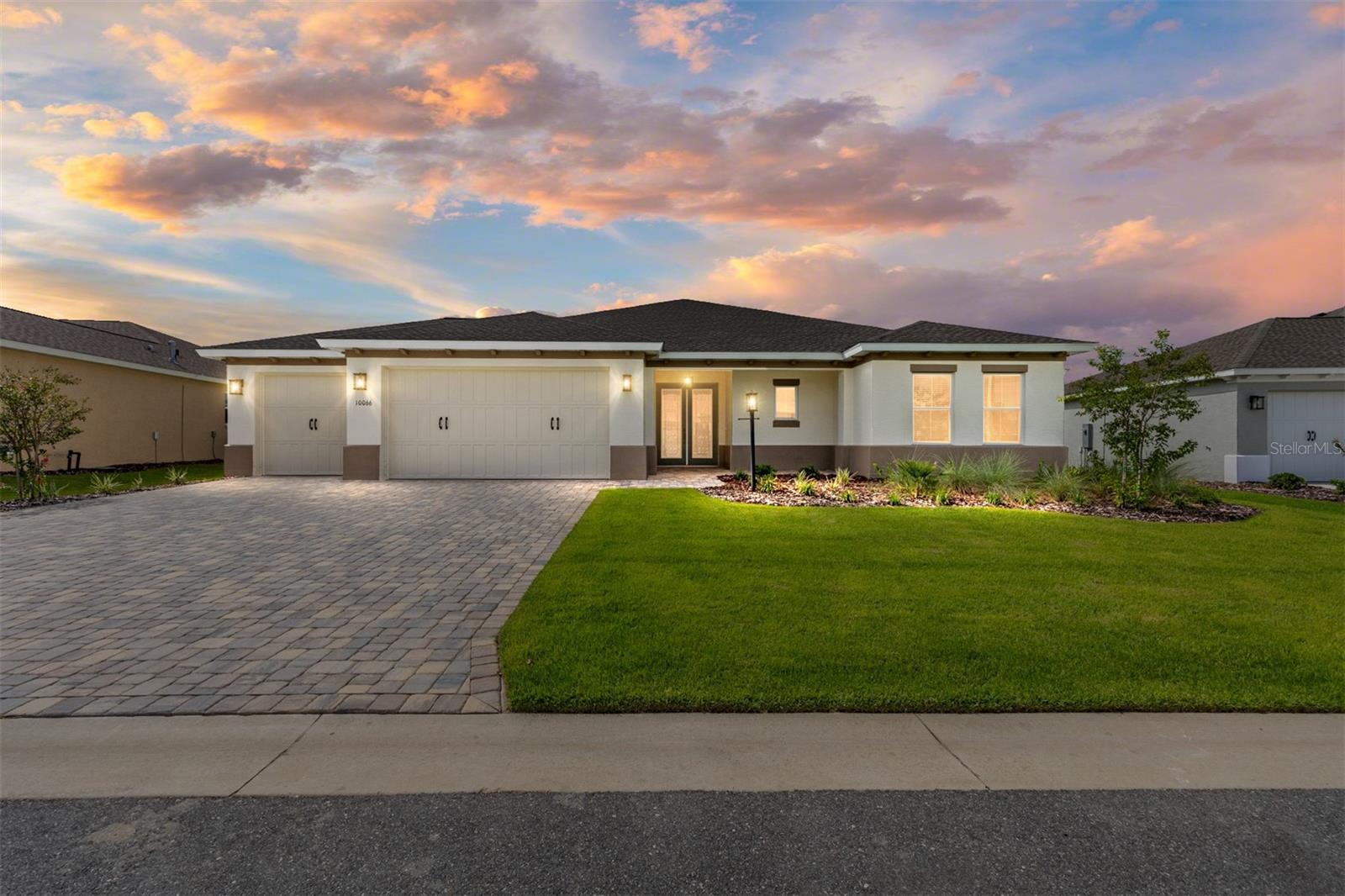 Welcome to the Wellington model, located in the sought-after Balfour community at On Top of the World. This beautifully designed home offers 3 bedrooms, 3 bathrooms, and a 3-car garage, with a paver driveway and walkway leading to elegant French entry doors. Inside, you’ll find tile flooring throughout and elegant tray ceilings that add a touch of sophistication to the open floor plan. A separate dining room provides the perfect space for gatherings, while the living area features a sliding glass door that opens to the screened lanai for seamless indoor-outdoor living. The chef’s kitchen boasts rich brown staggered cabinets with crown molding, built-in oven and microwave, 5-burner cooktop with range hood, stainless steel refrigerator and dishwasher, backsplash, under-cabinet lighting, walk-in pantry, and a large island. The private owner’s suite is a true retreat with a tray ceiling, 3-panel window overlooking the backyard, and a walk-in closet with convenient access through to the laundry room. The luxurious en suite features a double vanity sink with quartz counters, a zero-entry tiled shower with a built-in bench, and a linen closet. One of the guest bedrooms also offers a walk-in closet and its own en suite with a single vanity and a tiled tub/shower combination, perfect for visiting family or friends. Designed with comfort and style in mind, the Wellington model offers modern finishes, spacious living, and thoughtful details—ready for you to call home. Residents of On Top of the World enjoy an active-adult lifestyle with access to championship golf courses, fitness centers, swimming pools, pickleball and tennis courts, walking trails, and a wide variety of clubs and social activities.