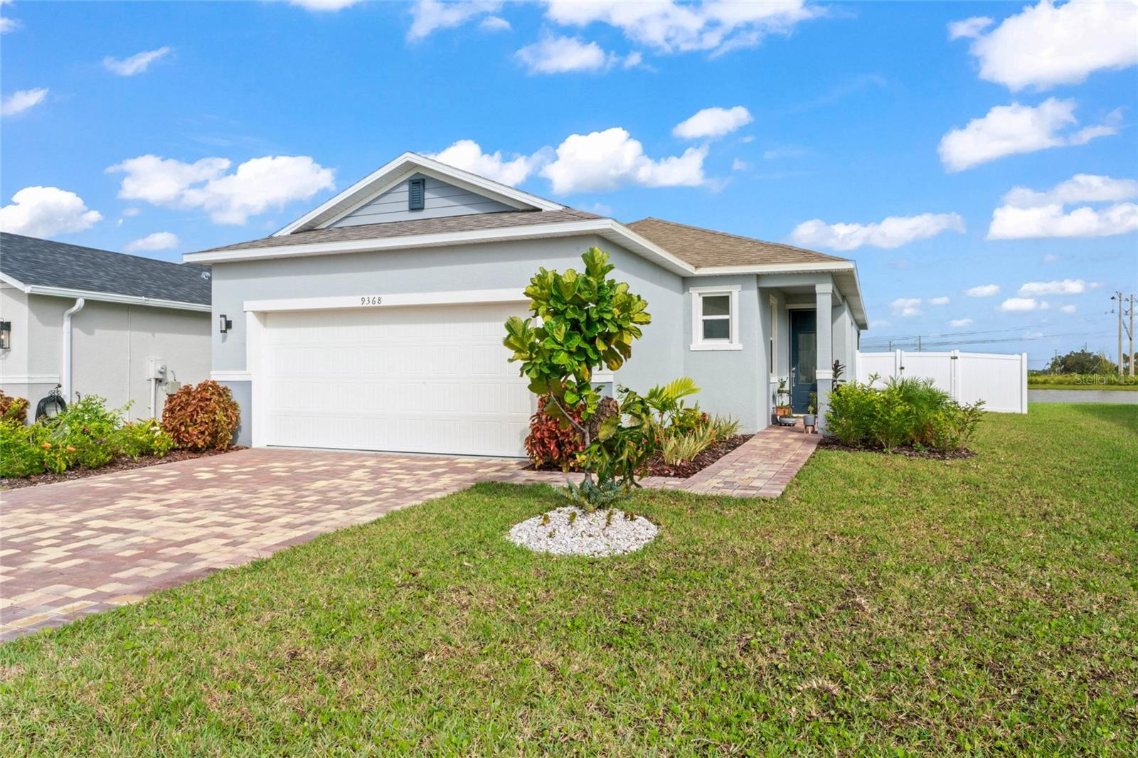 Sawgrass Lakes features this beautiful 3-bedroom, 2-bathroom home with a stunning pond view. Luxury vinyl plank flooring runs throughout the entire residence. The kitchen boasts 42-inch white cabinets, granite countertops, and stainless steel appliances, and it overlooks the dining and living areas. The split-bedroom layout provides privacy for both guests and family. The primary suite includes a walk-in closet and a spacious en-suite bathroom. The secondary bedrooms also have walk-in closets. Relax and enjoy the pond view from the screened lanai with epoxy flooring. Additional upgrades include an epoxy garage floor, a vinyl-fenced yard, upgraded appliances, including a washer and dryer, knobs & handles on cabinets and drawers, custom lighting fixtures, upgraded paint, and enhanced landscaping throughout the exterior, pavered driveway and sidewalk.
