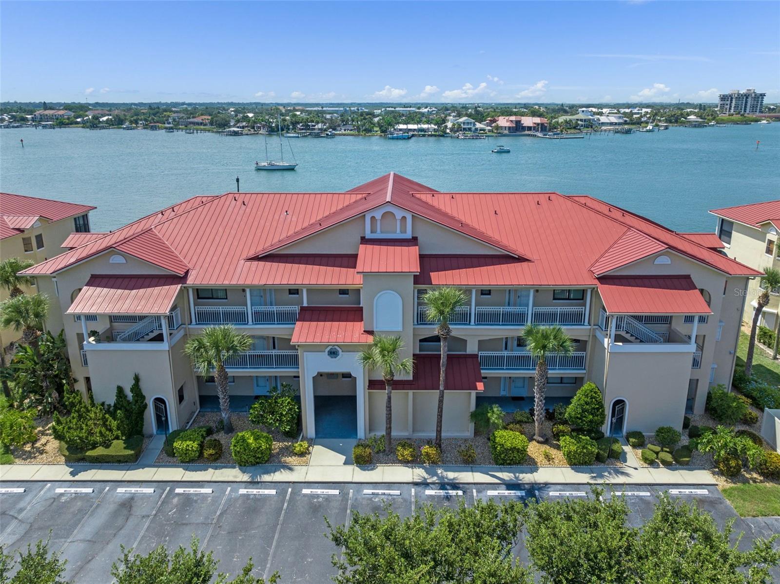 Experience coastal living at its finest in this fully renovated and fully furnished 2nd-floor waterfront condo, where panoramic views of the Intracoastal Waterway greet you from every angle. Whether you're lounging in the living room or unwinding on your private balcony, you'll be treated to unforgettable sunsets, dolphins dancing in the waves, boats gliding by, the festive Christmas boat parade, and spectacular 4th of July fireworks all from the comfort of your own home. This unit has undergone a complete top-to-bottom renovation, featuring modern finishes. It’s being sold fully furnished with stylish, turnkey décor, making it truly move-in ready just bring your suitcase and start enjoying the lifestyle. Located in a vibrant waterfront community, residents enjoy access to 2 heated swimming pools, tennis courts, a golf course, fitness center, clubhouse, and tiki bar. Boating enthusiasts will appreciate the private boat launch and storage, as well as brand new dock and boat slips available through the association. For those who love the outdoors, there’s a fishing pier and a scenic half-mile riverwalk to explore. With city water and a prime location close to beaches, dining, and entertainment, this condo offers the perfect blend of comfort, convenience, and coastal charm. Whether you're seeking a full-time residence, a vacation retreat, or a smart investment, this turnkey gem won’t last long. Schedule your private showing today and start living the waterfront dream.