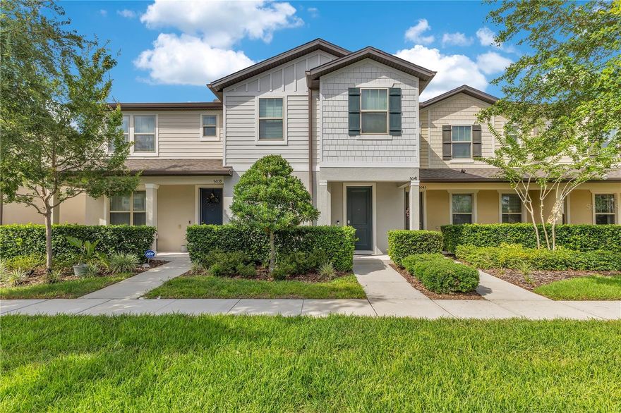 Behind the gates of Lakeshore at Narcoossee, this four-bedroom, three-bath townhome offers nearly 2,000 square feet with a two-car garage in one of St. Cloud's most sought-after communities. Step through the front door and the first bedroom and full bath sit right off the foyer. Use it as a guest room, a home office, an in-law suite, or a flex space. You decide. Past the entry, the floor plan opens up. New flooring runs through the main level, and updated light fixtures add a fresh, modern touch throughout. The kitchen anchors the space with granite counters, stainless steel appliances, rich cabinetry, and recessed lighting. The living and dining area flows off the kitchen, built for hosting and for everyday living. Sliders lead to your private pavered patio, with a breezeway that connects to the garage. Head upstairs and the laundry room is right there in the hallway, where you actually need it. The owner's suite sits to the right with room for a king bed and then some. The en suite features dual sinks, a tiled shower with a built-in bench, and a walk-in closet that earns its name. Two more bedrooms and the third full bath round out the second floor. Then there's the community. A 24-hour virtually guarded gate, a zero-entry resort pool, a clubhouse, a fitness center, a playground, swings, a basketball court, and a dog park. Lake access rounds it out with a fishing dock and boat slips. Location puts you close to everything. Lake Nona Medical City, restaurants, and shopping are a short drive. Orlando International Airport, the theme parks, and the beaches are all within reach, and 417 and 528 keep the rest of Central Florida easy to get to. Gated, four bedrooms, and move-in ready with fresh updates.