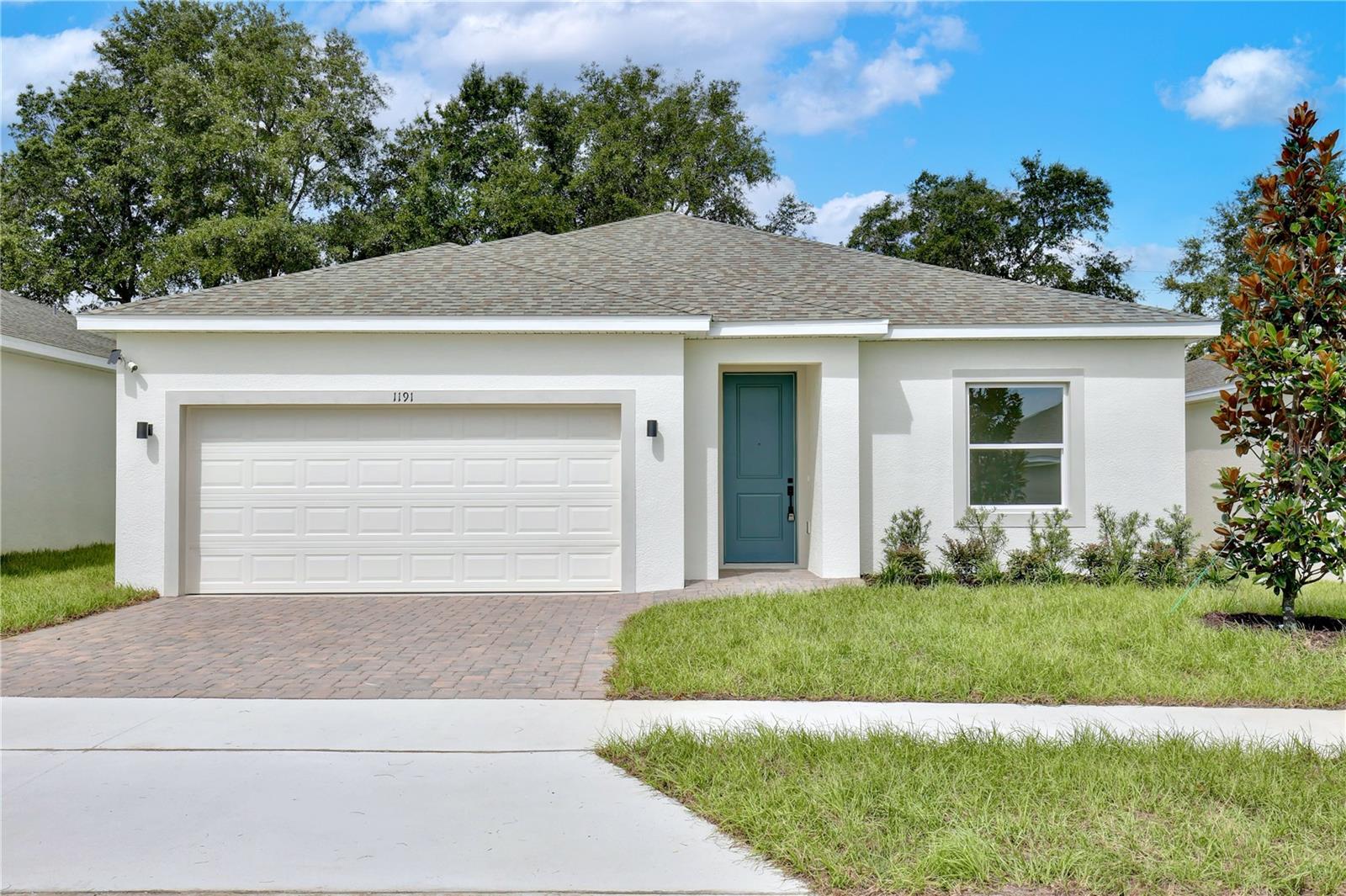 New Construction; Move-in Ready! LOW HOA AND NO CDD FEES. Seller is contributing up to $20,000 towards closing costs and interest rate buy-downs, with no lender requirement. Welcome to your dream home in the established Sunrise Ridge community of Groveland. As you enter through the impressive 8-foot tall front door, you'll be greeted by elegant porcelain tile flooring that flows through the spacious main living areas. The home is adorned with high-end finishes, including modern 6” baseboards and 4” casings, high-end door hardware, and upgraded plumbing and lighting fixtures, together adding a touch of elegance and sophistication.
Natural light pours in through oversized sliding glass doors, brightening the entire space and creating a welcoming ambiance. The home also offers several linen closets, providing abundant storage for all your needs. The primary bedroom features a generous walk-in closet, a premium ceiling fan, and an abundance of natural light through large windows. The en-suite bathroom is beautifully designed with a sleek glass shower enclosure complemented by double vanities and a spacious linen closet. The kitchen is a chef's delight, boasting upgraded cabinets with designer hardware, gorgeous quartz countertops, a large corner pantry, garbage disposal with air switch and stainless-steel appliances. An automatic garage door opener is also included for added convenience. The exterior features a stylish brick paver driveway and a spacious backyard with no rear neighbors, perfect for relaxing and entertaining guests. Enjoy convenient proximity to the Florida Turnpike, major shopping centers, and a variety of restaurants, all just a short drive away. Make this stunning new construction home in Groveland yours today!