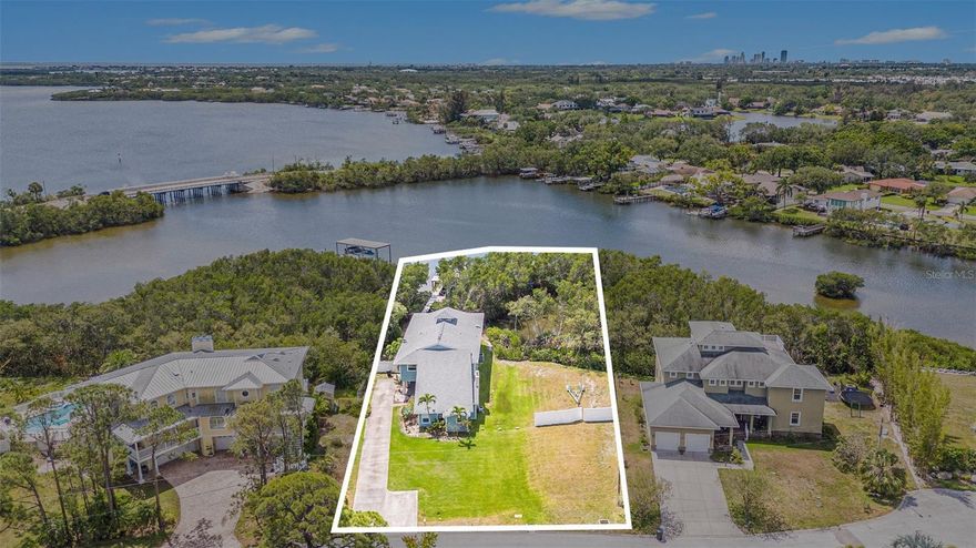 This is the LARGEST WATERFRONT lot AVAILABLE to build on in St. Pete under $1M. Live the waterfront dream on Riviera Bay in beautiful St. Petersburg! RARE HALF ACRE DOUBLE LOT with an opportunity to build your dream home. Nestled along the serene shores of Riviera Bay and surrounded by lush mangroves and tropical landscape, this property features 123’ of private/secluded water frontage on a huge 21,525 sqft lot. This open water retreat is located on an exclusive cul de sac and features a magnificent 130’ dock that recently had all the boards replaced with Trex composite decking. Boaters will appreciate the covered 9,000lb. boat lift with water and electric. Enjoy evening sunsets on the end of the dock or drop a fishing line towards the mangroves for some of the best fishing around. You will also enjoy the ease of being able to drop a kayak in from the shore and head out to Weedon Island Preserve and take in all that nature has to offer from bird and dolphin watching to fishing the mangroves for snook and redfish. Should you choose to build your dream home, and take advantage of this spacious private lot, the owners already have construction plans for a 4000sqft+ home with pool available to share! The ideal central location puts you only 10 minutes to vibrant Downtown St. Pete and 15 min to Downtown Tampa. Boaters will enjoy quick and easy access to open water and only 30 minutes to The Pier and Downtown St. Pete WITHOUT BRIDGE OR DEPTH LIMITATIONS. Embrace the Florida lifestyle, with award winning beaches, pristine golf courses and an abundance of outdoor recreational opportunities all within easy reach. Be sure to check out this amazing opportunity and get ready to live the Salt Life!