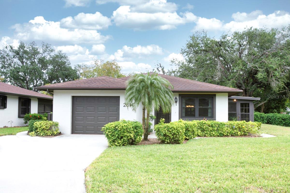 ARE YOU TIRED OF HIGH FEES? These LOW $275 MONTHLY FEES maintains your landscaping and offers MANY AMENITIES! You should investigate this WELL-BUILT single family home situated on a corner lot, that lives like a villa in a condominium neighborhood. You'll find this 2bdrm+, 2 bth offers beauty, durability and low maintenance costs from the STURDY STUCCO walls, NEWER WINDOWS in 2018 and A/C in 2022. The price reflects your opportunity to refresh and renew the easy living floor plan. The AIR-CONDITIONED LANAI/FLORIDA ROOM adds 112 sf more to the living space = 1209 sq ft. which is perfect for an office, music room/entertainment space and has its separate entrance from the outside. It provides room for your visiting guests from the north! The outside has been recently painted, and you can choose the color for your door! The walk-out GARAGE with full sized washer/dryer adds to your easy living. The PET FRIENDLY, 55+ favored community has planned get-togethers including parties/dinners at the recently decorated and clean club house with a library and kitchen. You'll enjoy the HEATED SWIMMING POOL, shuffleboard court and a BBQ grill. The FLORIDA LIFESTYLE doesn't end at your own piece of paradise. Take a 5 mile drive to ANNA MARIA ISLAND for the green flash sunset on the serene GULF WATERS. You can take the free trolley to the tiki hut restaurants or beachy boutiques for fun shopping. CAMBRIDGE VILLAGE WEST has easy access to all your needs. Blake hospital, doctor's offices, GT BRAY park and the YMCA are a few blocks away. Your grocery store and big box store with a gas station are less than 2 miles from home. This location is convenient to St. Armand's circle, Ringling museum, IMG Academy, marinas, golf courses, the arts/entertainment districts of Sarasota or Bradenton's Riverwalk, all the fine dining/fast food favorites, movie theatre, bowling and Robinson Preserve. Our own SRQ airport is a nice benefit for living in the GULF COAST of FLORIDA. It doesn't take long to drive to I-75 for trips to Tampa, Orlando or south to Naples and Miami! DON'T MISS OUT ON THIS OPPORTUNITY to BUY HOME WITH LOW $275 MONTHLY CONDO FEE!