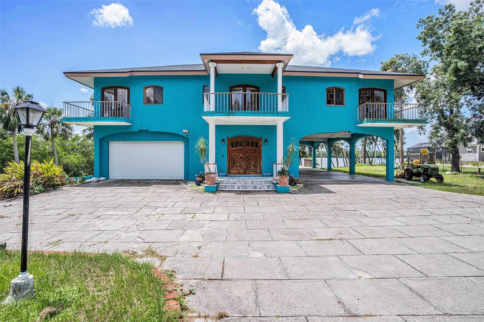 Your slice of paradise awaits! Check out the unparalleled opportunity of this unique waterfront property that offers room to grow or space to roam. Land development? Or create your own estate or family compound. This home is located on approximately 6 acres where you can enjoy captivating views of the Alafia River. Unique character abounds in the one of a kind home built by a former ship builder. Bring your vision and transform this diamond in the rough to your dream home. 4 bedrooms, 3 full baths and two half baths. Highlights include two en-suites, a beautiful kitchen with custom cabinets, stone fireplace, skylight with an art deco chandelier, beach themed master bath, walk-in attic, rooftop balcony and a massive enclosed garage area with multiple roll up doors. Ideally located, minutes to shopping, restaurants, medical and the interstate and minutes to Tampa Bay by water.