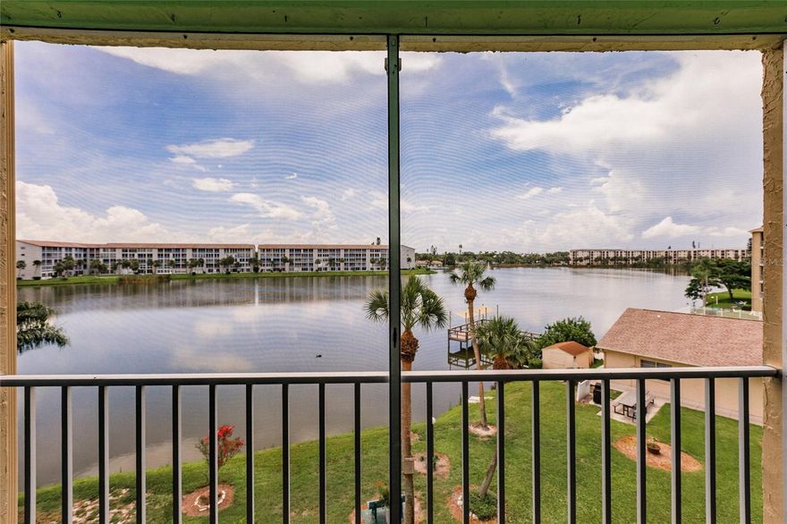 MOTIVATED SELLER!  Seller will provide a 13 mos. CHOICE ULTIMATE Home Warranty for your peace of mind!  With a panoramic view of the 19-acre Lake Bayshore, this updated 2b/2b, split bedroom plan in a 55+ community, is a must-see and priced to sell!  It boasts major updates like impact resistant sliders and windows, a newer A/C installed in 2021, and luxury vinyl plank throughout.  The light, bright kitchen has recently installed quartz countertops, stainless steel deep sinks and faucet, with updated ceiling and white appliances.  The passthrough to the dining room is adorned with a quartz breakfast bar.  The spacious dining room/living room combo is flanked by a custom slider leading you to the huge screened balcony from where you can feast your eyes on the morning sunrise over Lake Bayshore.   You will also enjoy the lake view from the primary bedroom, which not only has a large walk-in closet but also an ensuite bath and private office nook.  Another custom slider provides easy access from the primary bedroom to the private laundry closet on the balcony which houses a newer Samsung washer and dryer and something that is a rarity in most condos – a utility sink!!!  Both baths have updated vanities and toilets.  Modern fans have been installed in the kitchen, living room, both bedrooms and screened balcony.  Enjoy a day of fishing from the pier or kayaking on the lake.  Talk about LOCATION, LOCATION, LOCATION … in addition to this spectacular view, the unit is located just two doors from the elevator with an assigned parking spot in near the front of the building (see photo) and close to the pool & clubhouse.  Bayshore on the Lake is a friendly, amenity rich, active 55+ community in the heart of Bradenton, close to shopping, restaurants, the beaches of Anna Maria Island, downtown Sarasota, UTC Mall, the Ringling Museum, the Asolo Theater and the Manatee Players.  Monthly condo fee includes heated pool, clubhouse, shuffleboard, internet, basic cable tv, trash, exterior and grounds maintenance, building insurance, and management company.  Sorry no pets except for support animals (condo approval required).   All dimensions are approximate.  Schedule your private showing today!