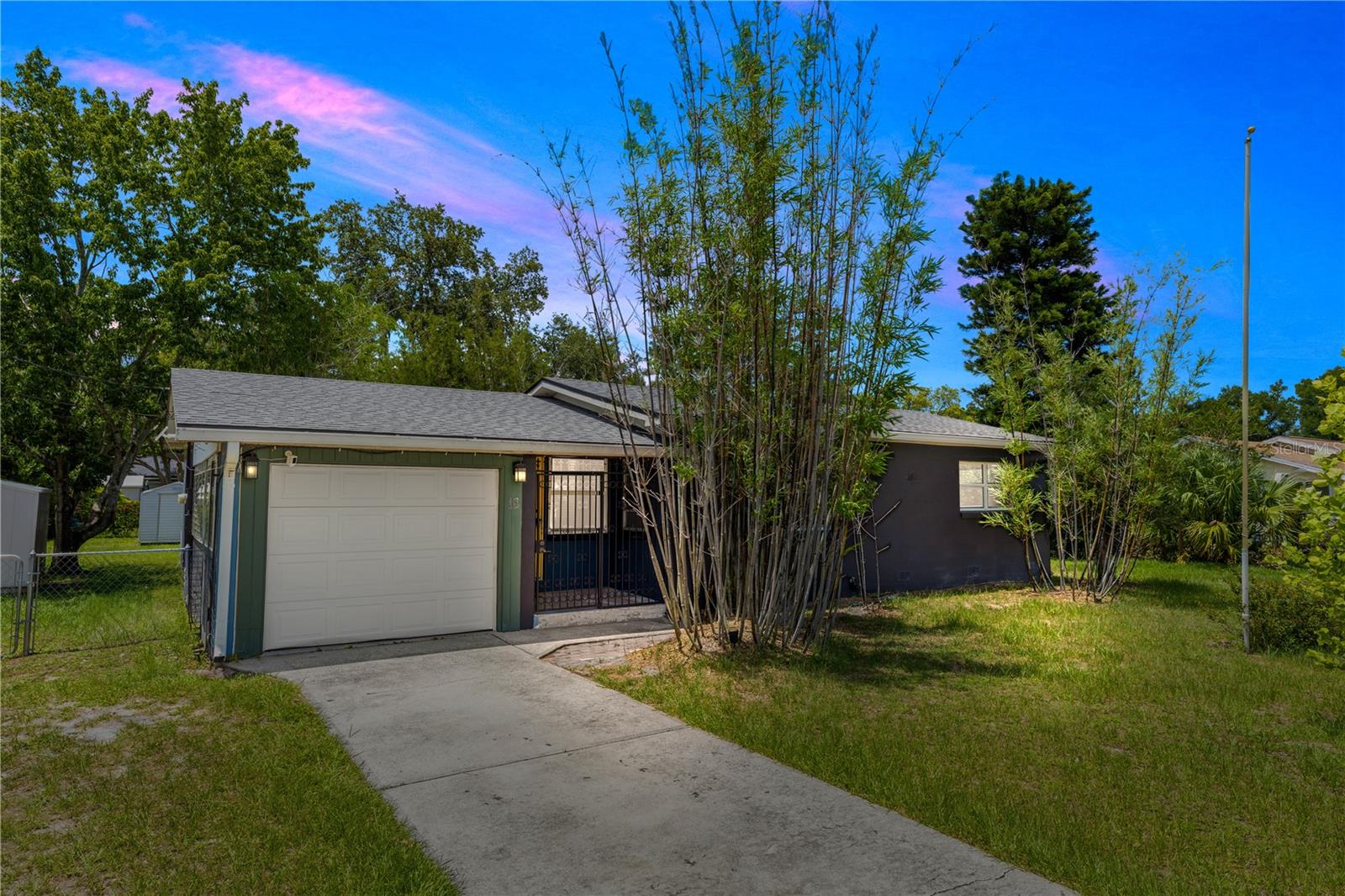 Charming 2-bedroom, 1-bathroom home nestled on an oversized, fully fenced .34 lot with endless outdoor features! Step inside and you'll find personality throughout, from the wood-accented ceiling in the entryway to the cozy shiplap walls in the living room. Real wood flooring graces the dining area and one of the bedrooms, while the second bedroom features plush carpeting. The spacious kitchen offers great functionality with room to customize, including a cabinet space ready for your finishing touch. The large laundry area includes a washer, dryer, and utility sink for added convenience. Enjoy outdoor living with two decks, a pergola, two sheds, and double-open fencing, perfect for additional access, storage, or recreational vehicles. The huge backyard offers plenty of room for play, gardening, or entertaining. Updates include a new roof (2021), A/C (2020), water heater (2020), and gutters. The home also features a 1-car garage, and furniture is negotiable, making this move-in ready home even more versatile. Full of charm, space, and potential. Don’t miss your chance to make this unique property yours, schedule your private tour today! This home may be under audio and visual surveillance.