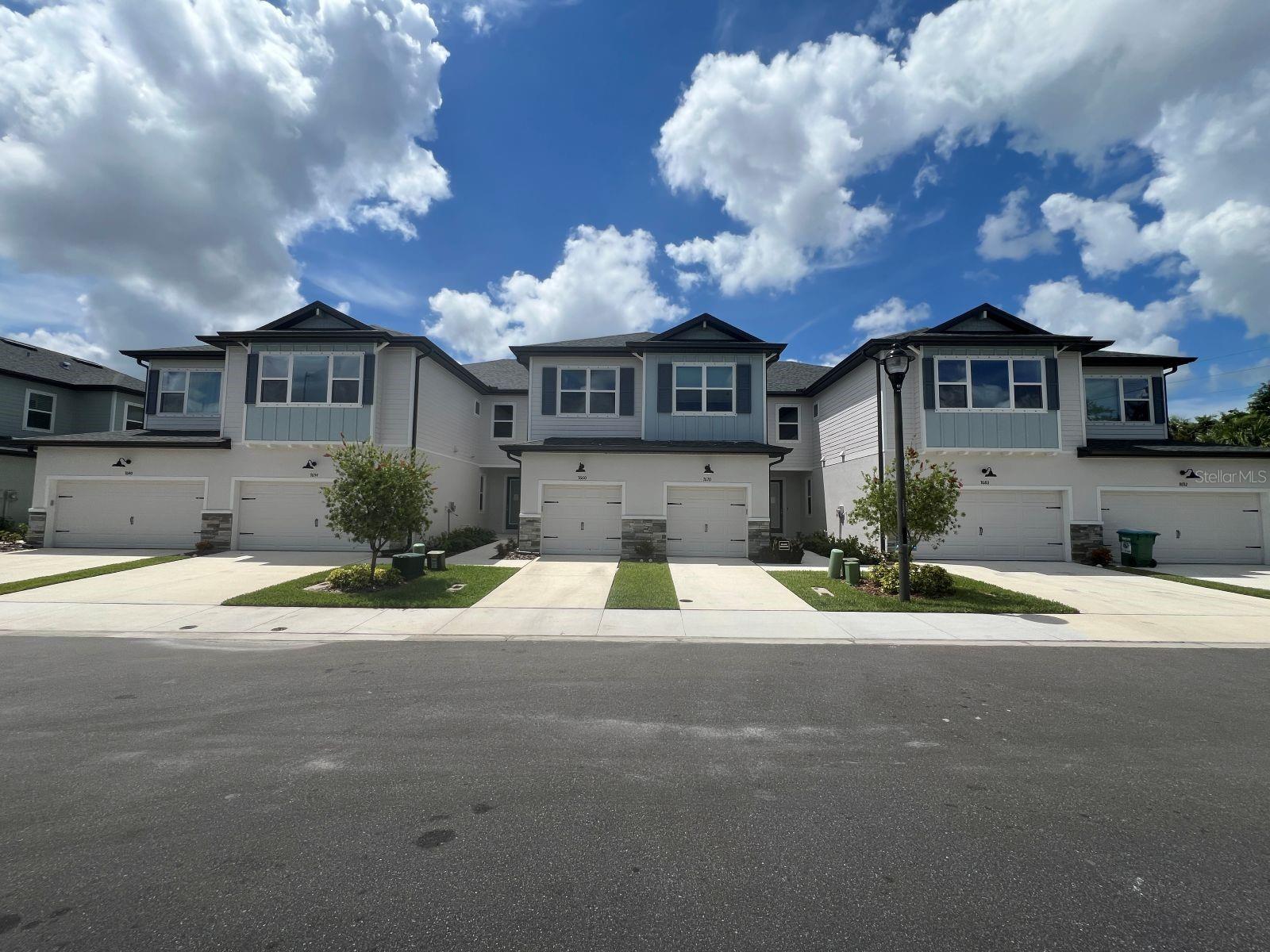Don’t miss your chance to own this award-winning B Model with a fountain view! This designer inspired residence features 3 spacious bedrooms, 2.5 bathrooms, and a 2-car garage, perfectly blending luxury, comfort, and convenience. Step inside to warm LVP flooring, light soft-close cabinetry with decorative hardware, upper-level quartz countertops, tile backsplash, and stainless-steel appliances—all set against a backdrop of peaceful fountain views. Tall 9'4" ceilings, oversized baseboards, and 8-foot doors enhance the open, airy atmosphere throughout. Upstairs, an intricate staircase with decorative iron spindles, oak treads and painted risers paired with 9' ceilings continue the open and airy feel that leads to the private living quarters. The primary suite offers tranquil privacy at the rear of the home, with a spa-like ensuite bath, high gloss designer tile from floor to ceiling, dual sinks, and stone countertops. The guest bedrooms are generously sized and filled with natural light thanks to thoughtfully placed oversized windows. Every detail has been curated for comfort and everyday livability, making this home warm, inviting, functional and luxurious. Located in flood zone X, just 2.5 miles from the beach, and close to shopping, dining, nightlife, and boating access. All this with well-maintained grounds and a low HOA!