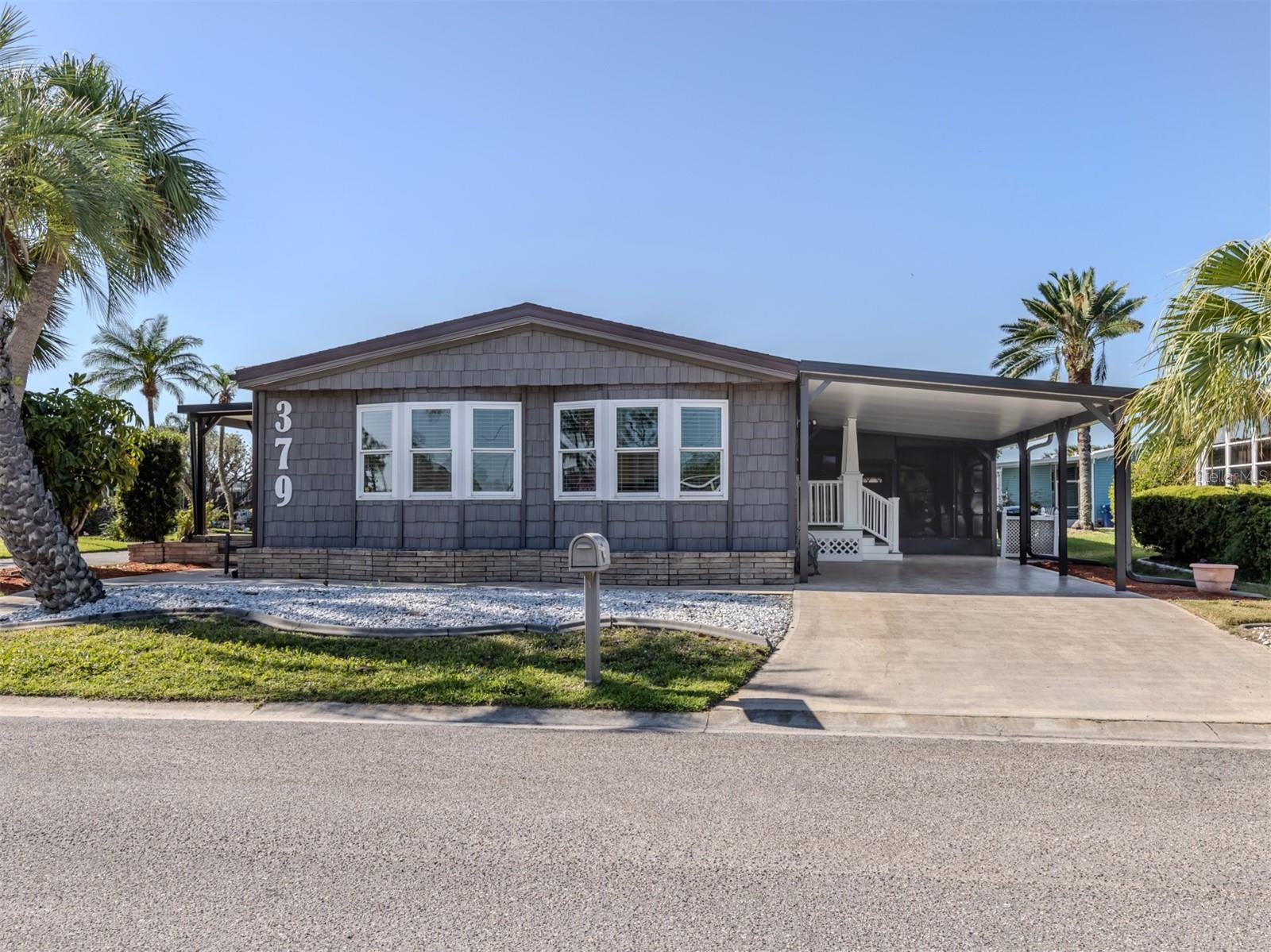 Welcome to this stunning 3-bedroom, 2-bath manufactured home offering 1,550 square feet of beautifully renovated living space in the highly desired, land-owned, pet-friendly community of Harbor Isles. Perfectly located directly across from the clubhouse and all of the community's fantastic amenities, this home delivers the ideal combination of luxury, comfort, and convenience. Every detail has been thoughtfully updated from top to bottom. The heart of the home is an impressive chef's kitchen featuring an oversized granite island with stylish designer lighting, brand-new stainless steel appliances, and an abundance of solid wood shaker cabinetry with gorgeous granite countertops. A matching dry bar in the living room and built-in buffet in the dining area create a cohesive look while adding even more storage and function. Engineered bamboo hardwood floors run throughout the home, enhancing the warmth and flow of the space. Vaulted ceilings with crown moldings add a touch of elegance and openness. The primary bathroom is a relaxing retreat, showcasing porcelain tile floors and a tiled shower, a double-sink vanity with marble countertop, a walk-in whirlpool tub, and a stacked washer and dryer for convenience. Exterior upgrades are just as impressive, including new siding with plywood sheathing and a moisture barrier, architectural shingle accents, a Cat 5 rated carport, new gutters and fascia, double-hung windows throughout, three new skylights, and extra tiedowns for added peace of mind. The roof was redone in 2023, the A/C system was replaced complete with all new ductwork in 2019, the water heater in 2021, and a whole-house surge protector was added in 2023.
This home is truly move-in ready and waiting for its new owner.