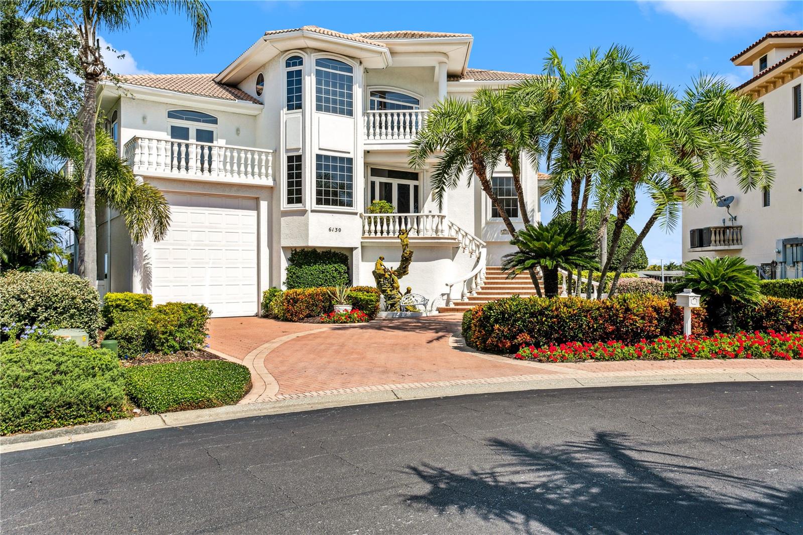 Under contract-accepting backup offers. Panoramic views of Boca Ciega Bay and the most spectacular sunsets can be enjoyed each day in this incredible 3 level custom home in the sought after neighborhood of Kipps Colony within Pasadena Yacht and Country Club. Positioned on a rare oversized corner lot with 141 feet of open sailboat water frontage, the location allows for very large boating vessels. Enter the paved driveway to a magnificent setting with a bronze ascension statue. Soaring 22' ceilings offer for an abundance of natural light and water views as you enter the front door. The main living level is a great open floor plan with a formal living area with marble floors and a gas fireplace. The living room flows perfectly into the dining area with a separate bar area with a wine refrigerator. The entertainment kitchen has expansive granite countertops with 2 sinks, a center island with a Dacor cooktop and built-in oven, Sub-Zero refrigerator, and Nichol's oak cabinetry. The dining room is located off of the kitchen and entrance with marble floors, a built-in oak and marble server, and tray ceiling provide the perfect ambiance for dinner parties. A separate office or bedroom, full bathroom and private guest suite with a private balcony and an ensuite bath complete the second level. Follow the floating staircase or take the hydraulic elevator (that goes to all 3 floors) to the third level with another guest suite, large landing, and private owner's suite. The owner's suite is expansive with a private balcony, leisure area, double walk-in closet, and large ensuite bathroom with a garden tub, shower, and dual vanities. The ground level provides an enormous space for entertaining and enjoying the quintessential Florida indoor/outdoor with a living room, full indoor kitchen, full bathroom, flex room, and new large sliders that open to the backyard. Soak in the sun on the paved patio, or host an outdoor gathering by the concrete outdoor kitchen with bar seating. Relax by the sparking Pebble-tech pool with sun shelves, and spa. The 3-car garage plus an RV garage that can accommodate an RV or 2 more cars, 4 more with the installation of a lift providing plenty of garage space for the car enthusiast! Other features include a barrel tile roof, 10,000 lb boat lift, surround sound throughout, newer HVACs and so much more! A coveted PYCC membership available without a waitlist to owners within the community with access to tennis, golf, renovated clubhouse and marina.