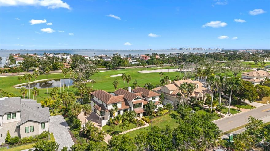 Distinctive Longboat Key Estate with Golf Course Views & Effortless Beach Access.
One of just 31 private estates behind the guarded gates of the Longboat Key Club, this exceptional residence offers over 5,100 square feet of thoughtfully designed living space with a striking architectural presence rarely found in the area.
The open layout includes five en-suite bedrooms, a dedicated office, and a versatile bonus room ideal as a second office, media room, or play space. At the heart of the home, a dramatic two-story living room with vaulted ceilings sets the tone for both grand entertaining and everyday comfort. A formal staircase greets guests near the entry, while a spiral stairwell connects the garage and mudroom to the kitchen and upper level. A three-stop elevator ensures easy access to all floors.
The magazine-worthy sitting room is framed by oversized windows that invite natural light and lush views, creating the perfect space to start the day with coffee or unwind with a book. The adjacent kitchen boasts dual islands and high-end Kitchen Aid appliances, and the formal dining room accommodates larger gatherings with ease. 
Outdoors, the heated infinity-edge pool offers a front-row seat to the fairways of the Longboat Key Club golf course, providing a tranquil backdrop of lush greens and daily activity. The dedicated pool bathroom enhances the convenience, while a covered outdoor dining area and summer kitchen with grill invite year-round al fresco living.
This home has been thoughtfully updated with a 5-year-old tile roof and ES hurricane impact windows and doors, ensuring peace of mind and long-term investment protection.  Generous closet and storage spaces throughout, include large walk-ins and a “Florida Basement” adjacent to the three-car garage.
Set just across the street from Regent Court, one of Longboat Key’s most exclusive Gulf-front streets and the site of the most expensive residential sale in the Sarasota region (over $30 million), this estate offers the rare opportunity to live among the highest echelon of Gulf Coast properties.
The south end of Longboat Key offers unmatched convenience, placing you just minutes from fine dining, shopping, and cultural attractions. Membership to the Longboat Key Club is optional but available, unlocking 500+ acres of luxury amenities including 45 holes of championship golf, tennis and pickleball courts, five restaurants, a spa, private beach club, marina, and fitness center.
And with public beach access just three homesites away, your toes can be in the sand within 3–4 minutes of leaving your front door.