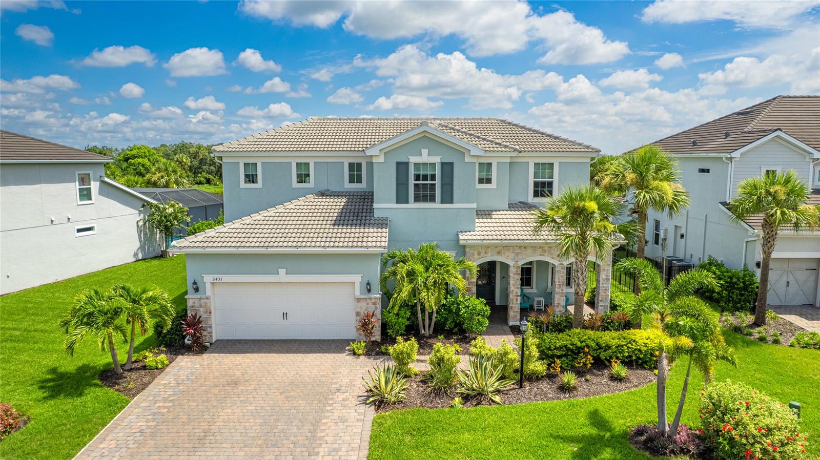 Experience refined living in this meticulously customized DiVosta-built Vanderbilt model, featuring 4 bedrooms, 3 full baths, and 2 half baths across more than 3,400 square feet of thoughtfully designed space in the coveted, maintenance-free gated enclave of Mallory Park at Lakewood Ranch. Perfectly situated on a premium waterfront lot with sweeping pond views and lush landscaping, this home delivers the ideal balance of upscale design and everyday functionality. From the moment you arrive, curb appeal shines with a paver driveway, stone-accented front porch, and mature tropical landscaping that frames the home’s inviting exterior. Inside, a bright and open layout sets the tone with a chef’s kitchen featuring extended countertops, built-in wine fridge, walk-in pantry, and a butler’s station. The main floor includes the primary suite with a custom walk-in closet, an office, and a large laundry room equipped with a new washer and dryer installed in 2024. Upstairs, a spacious loft with custom built-ins serves as a bonus living area or media room, accompanied by three guest bedrooms, a Jack and Jill bath, and an additional full bath to accommodate guests or growing households. Designed for indoor and outdoor living, the backyard is a showstopper. Enjoy your private 34x14 heated saltwater pool and spa with color-changing LED lights, a fully screened lanai with paver decking, and a custom outdoor kitchen equipped with a stainless grill, sink, refrigerator, and ample storage. A pool bath adds convenience, while the fully fenced 10x50 dog run is a rare bonus for pet lovers. Every detail has been considered, from ceiling fans in every room to finished garage storage with ceiling racks and shelving. This home is truly move-in ready and offers more than new construction. Mallory Park offers a lifestyle that goes beyond the home, with resort-style amenities including a zero-entry pool with lap lanes, state-of-the-art fitness center, clubhouse, playground, basketball and pickleball courts, and scenic walking trails. Enjoy direct access to Bob Gardner Park with a dog park, disc golf, ball fields, and playgrounds. A private walking path leads to top-rated Lakewood Ranch schools, and you’re just minutes from premier dining, shopping, downtown Sarasota, UTC, and Gulf Coast beaches. **THIS PROPERTY QUALIFIES FOR A 1% LENDER INCENTIVE IF USING PREFERRED LENDER. INQUIRE FOR MORE DETAILS.**