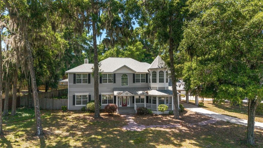Welcome to this stunning Victorian-inspired residence, where timeless architectural charm meets modern comfort and thoughtful design. Offering five bedrooms and four full bathrooms, this beautifully renovated home provides exceptional space, flexibility, and functionality—ideal for multigenerational living or those relocating and seeking a move-in-ready lifestyle.

Perfectly positioned in a desirable area near the Frank DeLuca YMCA, Publix, parks, shopping, dining, and top-rated schools, the location offers both everyday convenience and a strong sense of community.

From the moment you arrive, the inviting wraparound porch sets the tone, overlooking a peaceful private pond and creating the perfect space to unwind. Inside, the home showcases a seamless blend of character and modern upgrades, including high ceilings, a formal living room, and a dedicated dining space designed for both entertaining and daily living.

The fully updated kitchen serves as the heart of the home, featuring stone countertops, new cabinetry, updated appliances, and ample space for casual dining. Designed with versatility in mind, the property offers primary suites on both the main level and upstairs, along with laundry rooms on each floor—providing comfort and convenience for extended family, guests, or flexible living arrangements. Dual staircases further enhance accessibility and flow throughout the home.

Step outside to your private outdoor retreat, complete with a screened-in pool and generous patio space, ideal for year-round enjoyment. The detached three-car garage and additional parking provide ample room for vehicles, storage, or hobby space, while the covered portico offers added convenience during Florida’s seasonal rains.

Recent improvements—including a new roof, HVAC system, pool pump, and garage door opener motors—offer peace of mind for buyers seeking a turnkey property. Combining Victorian-inspired design with modern updates, scenic surroundings, and a highly convenient location, this home presents a rare opportunity for those seeking space, comfort, and long-term livability.

A must-see property for buyers looking to relocate or accommodate multigenerational living without compromising style or function.