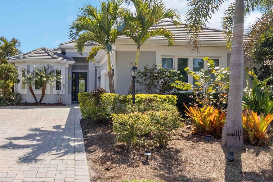 This beautifully enhanced WATER VIEW Augusta model set within the prestigious 24-hour guard-gated community of Rosedale Golf & Country Club—is where there are NO CDD fees and the lifestyle is elevated to an art form! This refined residence showcases soaring 12 FOOT CEILINGS, elegant 8-FOOT INTERIOR DOORS, DESIGNER TILE flooring, and a light-filled OPEN GREAT-ROOM layout designed for both sophisticated entertaining and comfortable everyday living. The CHEF-inspired kitchen with stainless steel appliances seamlessly connects to a custom fireplace and TV feature wall, while thoughtful UPGRADES—including luxury vinyl plank flooring, a professionally designed primary closet, built-in bookcase and curated shelving, designer window treatments, upgraded fixtures, and a premium HVAC UV light system—reflect meticulous attention to detail. Outside, enjoy a paver brick driveway and walkway, impact-resistant windows and doors, durable tile roof, retractable indoor lanai screen, gas hook up for a grill or outdor kitchen... lush professional landscaping, and full gutter system for long-term efficiency. The flexible floor plan offers 3 spacious bedrooms, a private den ideal for a home office or media retreat, 3 full designer baths, and a 2-car garage. Residents of Rosedale enjoy an active, resort-inspired lifestyle with GOLF, TENNIS, FITNESS CENTER, CLUBHOUSE DINING, heated Junior Olympic pool, bocce ball, vibrant social clubs, and year-round events, while the HOA provides exceptional value including manned gates, security, cable, high-speed internet, lawn care, community management, and common area maintenance. Perfectly positioned just beyond the gates are A-rated schools and quick access to Lakewood Ranch, UTC’s premier shopping and dining, medical facilities, gyms, I-75, Sarasota-Bradenton International Airport, downtown Sarasota, and some of the nation’s top-rated beaches including Siesta Key, Lido Beach, Anna Maria Island and more!—Experience luxury country club living at its finest.