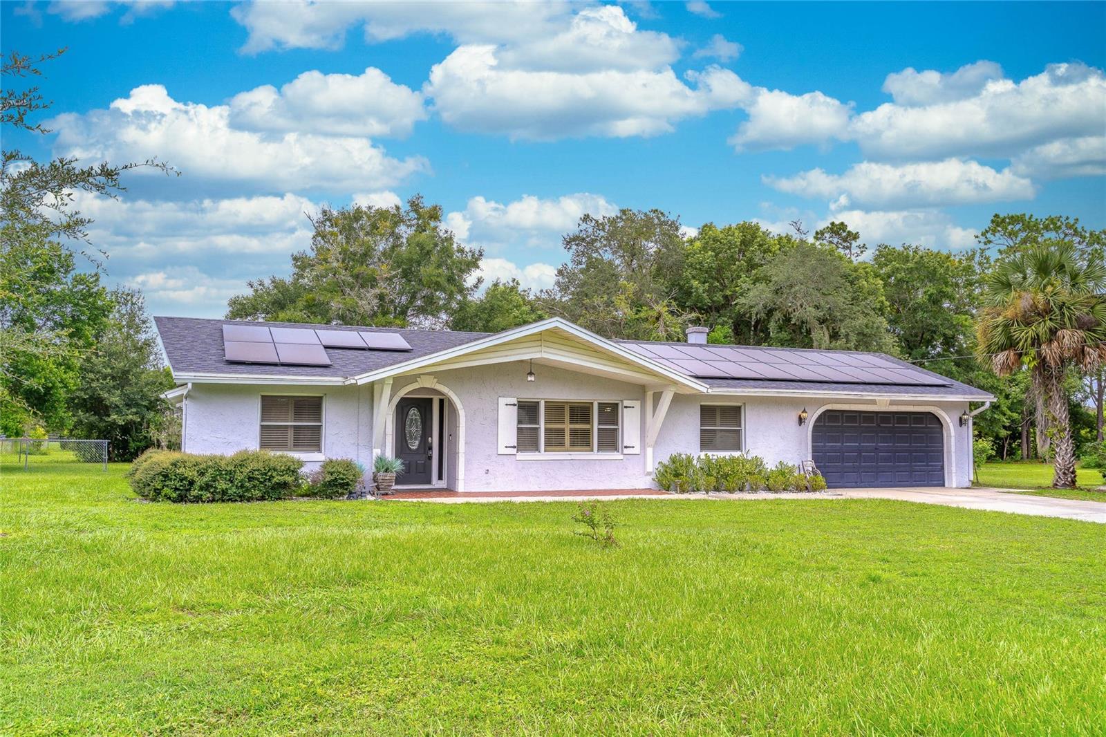 Welcome to 1200 Adams St - A Rare Opportunity in the Heart of Longwood! Nestled in a beautiful tree-lined neighborhood filled with lush green spaces, this charming home perfectly blends location with long-term value. Boasting 4 bedrooms and 2 bathrooms with a generous bonus room, it's perfectly suited for families and remote workers alike. The home is set on 1/3+ acre with a fully fenced back yard, allowing ample room for outdoor living, pets, gardens, or a future pool. Key updates offer peace of mind for years to come — including a new roof (2023) and solar panels (will be paid off at closing) delivering incredible energy efficiency with no additional cost. The HVAC system was replaced in 2016, adding to the home’s solid mechanical foundation. Inside, is a blank slate, ready for your personal touch. Whether you're looking to design your dream kitchen, reimagine the living spaces, or just want something move in ready, this mid-century ranch home checks so many boxes, all with NO HOA. Enjoy the best of Central Florida living with a prime location just minutes from I-4, offering easy access for trips to our world-famous theme parks, restaurants, sports venues, and of course our state's stunning beaches. Whether you're commuting for work or exploring the area’s countless attractions, you’ll absolutely love the convenience this location provides. Don’t miss your chance to own a home with great bones, unbeatable location, and room to make it your own. Schedule your showing today!