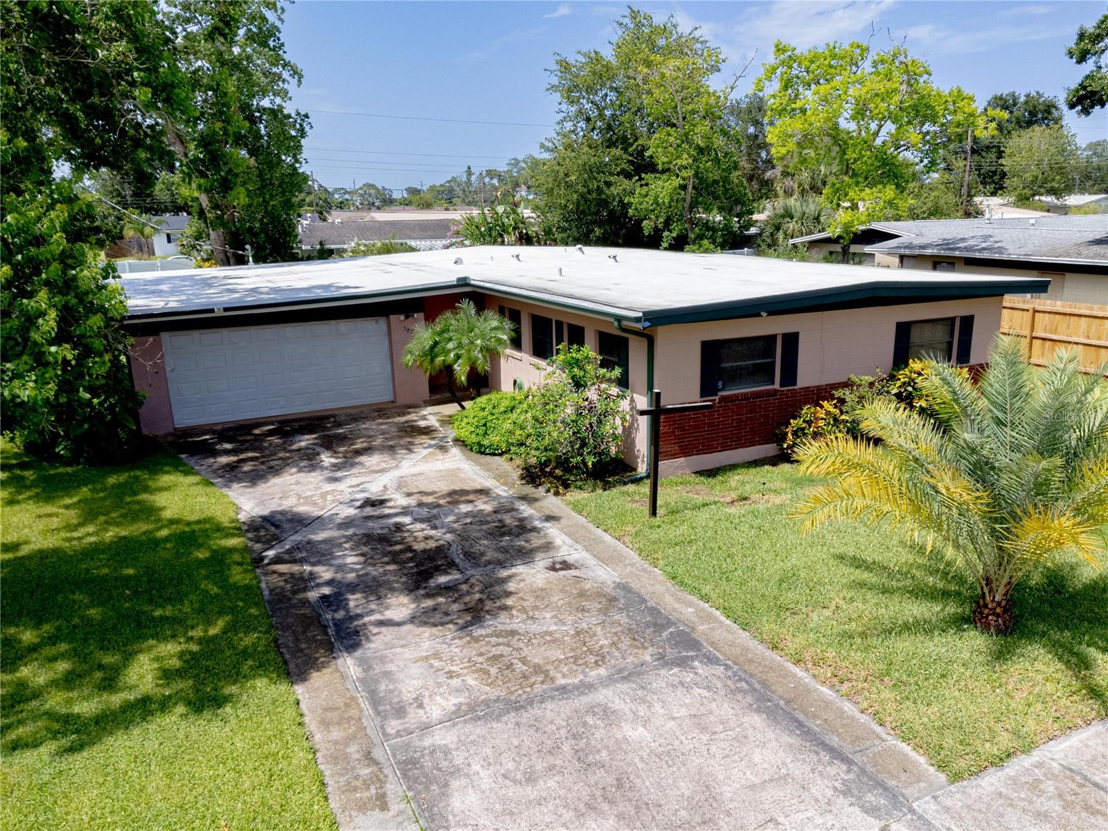 This well-maintained, solidly built 3-bedroom, 2-bath home is tucked away in a quiet neighborhood not far from the Intracoastal, Kennedy Space Center, and Canaveral National Seashore. Each bedroom offers spacious closets and brand-new ceiling fans. At the entry, you'll find a beautiful cedar-lined closet for added character. Fresh paint and ceramic tile flooring run throughout the home, complemented by upgraded door locks for peace of mind.
The two-car garage includes a reinforced door, new motor, and a dedicated workshop space—ideal for projects or storage. Step outside to enjoy the newly installed privacy fence surrounding the backyard, mature shade trees, and an enclosed porch. Additional features include exterior security cameras, proximity to shopping, dining, schools, and more. Plus, a transferable home warranty adds extra value for the new owner. Don't miss this one—it's a must-see!