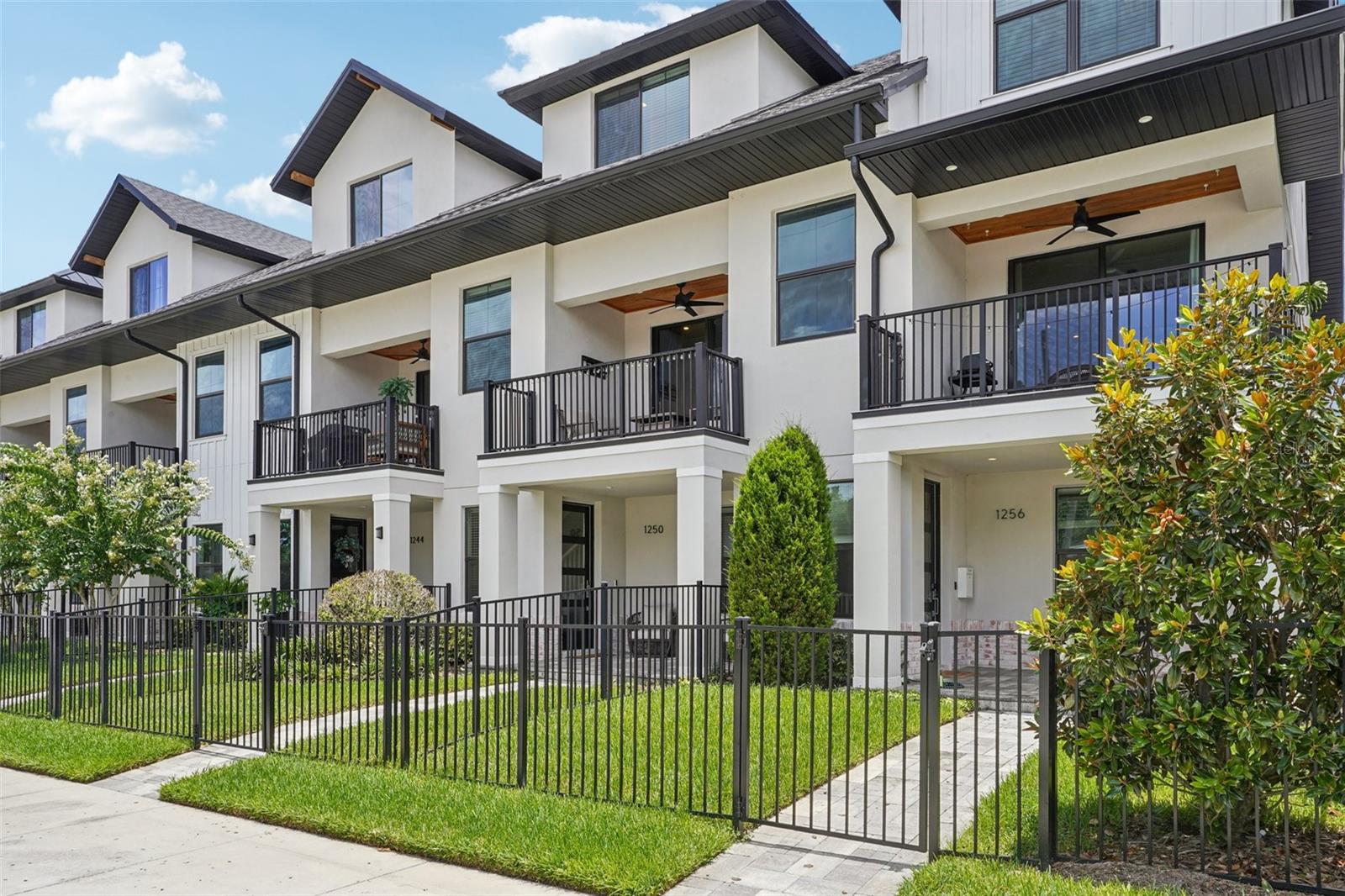 Modern living meets unbeatable location in this stunning 3 bedroom, 3.5 bathroom home nestled in the highly sought-after Urban Green Community. Built in 2022, this move-in ready residence showcases sleek, contemporary finishes throughout all three levels. Step up to a welcoming covered and pavered front porch, fenced-in front yard, and into a thoughtfully designed layout. The first floor offers a private bedroom with its own walk in closet and ensuite—perfect for guests or a home office. On the second floor, enjoy open-concept living with a bright and airy great room featuring high ceilings, recessed lighting, and seamless access to an oversized balcony through sliding glass doors. The modern kitchen is a showstopper, complete with quartz countertops, stainless steel appliances, a walk-in pantry, white shaker cabinets and a large center island with breakfast bar seating. Upstairs, you'll find two additional bedrooms, including the spacious primary suite with a walk-in closet, double vanity, glass-enclosed shower, and built-in shelving. The third bedroom also includes its own ensuite for added privacy and comfort. Additional highlights include an oversized rear-entry 2-car garage, laundry room, ample storage, and low-maintenance living. Enjoy unbeatable proximity to I-4, Downtown Orlando, Dubsdread Golf Course, Rollins College, Park Avenue, and Winter Park Village—offering endless dining, shopping, and entertainment options. This modern gem offers the best of both worlds: a turnkey home in a central, vibrant location. Don’t miss your chance to own in one of Orlando’s most desirable areas!