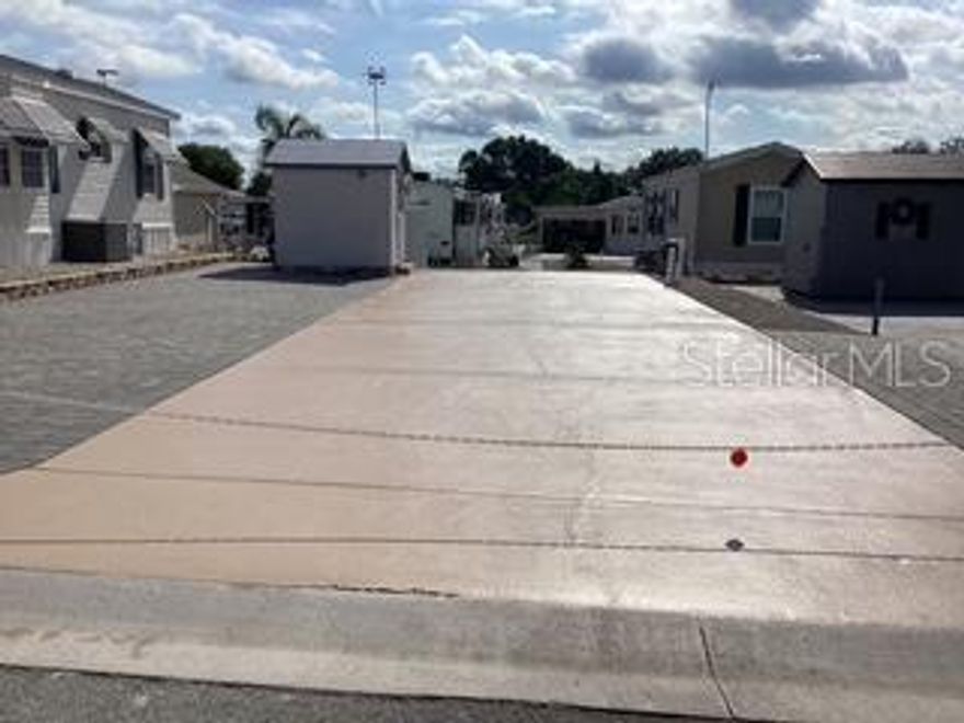 Gated 55+ Mobile Home Park. You own the land.  No mowing as this lot is fully paved. Ready for your Camper, Motorhome, Park Model home, or Modular home. Shed contains a full size refrigerator, washer & dryer.  This property is eligible for Homestead Exemption if it is your full time home; meaning lower taxes. Water & garbage is billed by the City of Davenport. At this time the Sewer is included in your LOW ANNUAL fee of $696.00. The February park meeting may raise it a few dollars. The inground pool  and spa are heated electrically, and has an outside entrance to the restroom and showers. Many events are planned from arts & crafts, line dance lessons, Wednesday grilled hot dogs & hamburgers for a small fee, pot luck dinners, Thanksgiving meal, Easter meal, Christmas meal and much more. Located just 3 miles to Advent Hospital and many doctors, dentists, and opticians. Posner shopping center near I-4 has many of the national stores. Close to I-4 for driving to the parks or beaches or Orlando area entertainment.