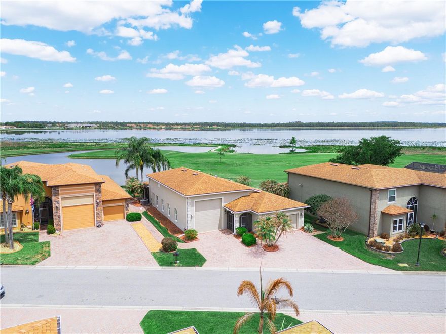 IDEAL LOCATION! AMAZING VIEW!!!! 4129 Limerick Drive Lake Wales, Florida is located on the 1st hole of Lake Ashton's East Golf Course. The location of this DeSoto RV home is desirable and offers a spectacular view of the morning sunrise over Lake Ashton. You'll enjoy the unobstructed golf and water views from one of the best lots in Lake Ashton. This 3 Bedroom / 2 Bath RV home offers a double car garage (20x21) and an RV garage (52 Ft) with hook ups. The exterior of this home is enhanced by concrete decorative edging and a paver walking path leads to the back on the home.  Enter thru the screened front entry into this RV home in Lake Ashton. The screened front lanai, leaded glass front door, side lights and storm door provide a warm welcome.  The double car garage and RV garage are both accessible from the foyer of this home. The air conditioned RV garage with epoxy coating is 52 ft. long, offers a wash sink, ventilation fan and the washer/dryer are located in this garage, too.  The 2 car garage has an automatic screen and provides privacy and ventilation into the space. The kitchen has been updated and is located just beyond the foyer of this home. Offering an Island with pull out drawers, step up breakfast bar with pendant lighting, 42" soft close cabinets with under cabinet lighting, Quartz counter tops and Stainless Steel appliances, the kitchen is a popular gathering spot. There are pull outs in select cabinets. The large combination living and dining room can easily accommodate your entertaining needs. The crown molding, tile plank flooring, custom ceiling fans and solar tubes add class to this RV home in Lake Ashton.  The dinette and adjacent family rooms are perfect locations for enjoying the fantastic views this home offers. The family room has newer windows and sliding doors that lead to the paver pad.   The guest rooms with carpet and ceiling fans are located directly off of the kitchen. The guest bath with shower/tub combo and comfort height vanity with Quartz counter top is conveniently located for guests, too. The primary suite with a separate split A/C is located on the back of the home and provides amazing water and golf course views. The primary suite has a large walk in Closet, and separate bath with a comfort height  vanity with Quartz counter top, walk in shower with glass door enclosure, linen closet, elongated toilet and upgraded lighting. The enclosed lanai with tile flooring and Acrylic windows is located on the north side of the home. It has a separate split A/C system allowing you to enjoy the room year round. Schedule an appointment to tour this RV home in Lake Ashton. Lake Ashton is a gated and guarded Florida Active Community with resort style amenities (2 Clubhouses with Movie Theater, Restaurant, Outdoor/Indoor Pools, Fitness Centers and More! Residents enjoy activities like Karaoke, Trivia, Dances, Entertainment Series, Holiday Events and so much more. You can stay busy living the Florida Retirement Dream every single day. For those that love the game of golf, there are 2 18-Hole Golf Courses, a Pro Shop, Driving Range, Putting Green and the Eagles Nest (Hole 19). Don't wait to tour this home; tour it today! Furniture Included!