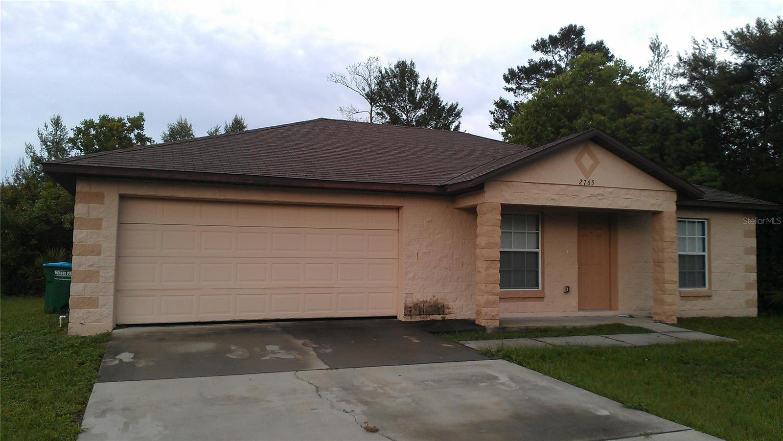 Spacious three bed, two bath home in Deltona. Tile and laminate floors throughout. Sliding doors lead to patio from eat-in kitchen with breakfast counter, large closet pantry and convenient utility closet with hookups ready for your washer & dryer. Split floor plan has primary bedroom with private bath and walk-in closet. Two more bedrooms that share a hall bath. Concrete block construction, 2 car garage and covered front porch.