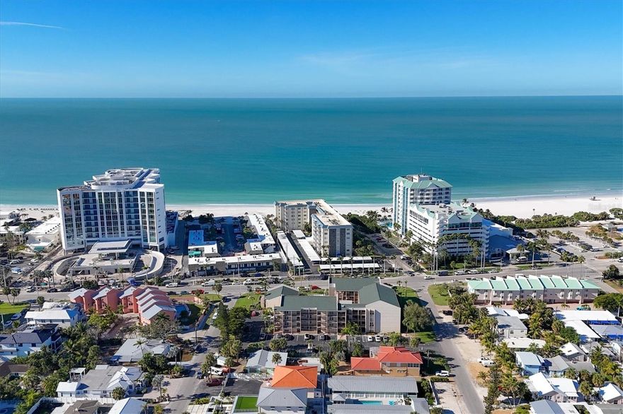 Coastal ease meets everyday convenience in this ground-floor retreat on Lido Key—just steps to the sand with beach access right across the street. Shade trees protect a private, fenced lanai paved in classic red brick; triple sliders open from the Florida room so indoor and outdoor living flow as one. Accordion shutters allow quiet separation when desired, or open wide to create an airy great room for gathering. The kitchen carries a fresh, coastal-meets-club vibe in its countertops and invites company to linger at a breakfast bar that comfortably seats three. A generous dining area, framed by floor-to-ceiling bead board, adds character rarely found today. The split plan enhances privacy: the north-facing primary suite avoids harsh morning sun and features a spacious walk-through closet to an updated bath with full shower, while the guest bedroom sits at the opposite end of the home. Live like you’re on vacation—pop over to the Lido Beach Resort, wander down to the Lido Pavilion to socialize, then head to St. Armands Circle for dinner and boutique shopping. Love the outdoors? Enjoy bike lanes along Benjamin Franklin Dr. and trails through both North and South Lido Parks. Whether you’re escaping for the season or sneaking away for the weekend, this easy, low-maintenance condo is the perfect lock-and-leave beach haven.