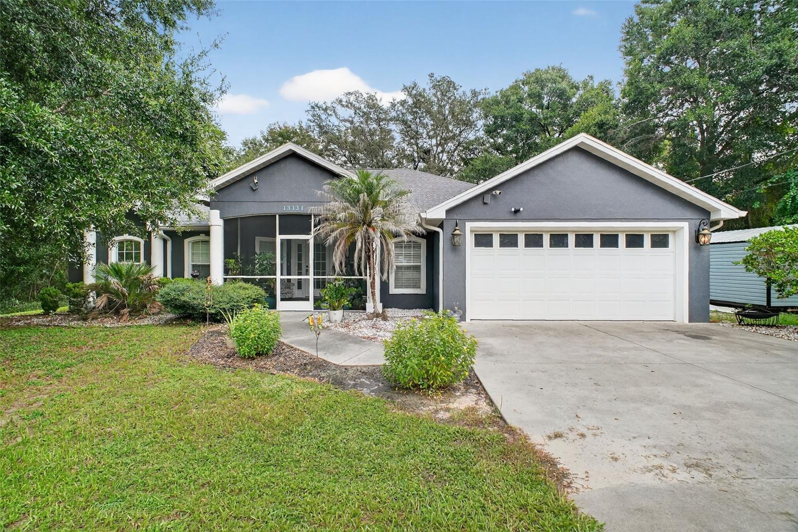Welcome to this newly renovated 4 Bedroom, 2 Bath, Block/Stucco home! With 2,176 sq ft of heated/cooled living space, VAULTED CEILINGS, UPDATED KITCHEN, a NEW ROOF in 2024 and NEW LUXURY VINYL PLANK FLOORING in the main living area (kitchen, dining, family room), this home has plenty of space and upgrades! There are matching GRANITE COUNTER TOPS and SOLID MAPLE GLAZED CABINETS in the kitchen and both baths and additional seating to entertain guests around the raised tiered bar top. The Master bedroom offers an en-suite bath with a garden tub for "bubble bath relaxation" and a separate walk-in shower, toilet and walk-in closet. Bedrooms 2 and 3 are nicely sized with a shared bath and Bedroom 4 is also nicely sized and has its own en-suite GAME ROOM / TV ROOM. The split bedroom floor plan makes a great layout for growing families, privacy, and out of town guests. The large 0.4 acre yard is partially fenced in with a BRAND NEW WOODEN FENCE for privacy, security and a welcoming space for outdoor fun and an enclosed covered lanai for grilling and entertaining. The mature landscaping and location makes this retreat private and peaceful, yet close to shopping, hospitals, restaurants and more being nestled in between Ocala and The Villages. The 2 Car Garage has room for toolboxes and a refrigerator/freezer. There is NO HOA so bring the toys, boats, sheds, etc. Come and see this hidden gem today!! The Roof also has a transferable warranty to the new owners!