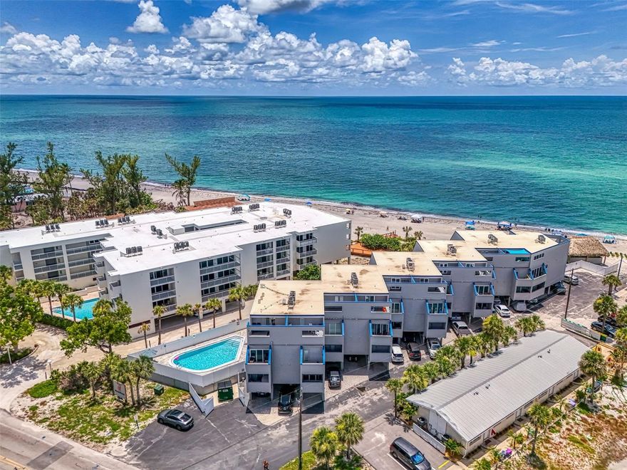 Listing reflects peak season monthly rate - it is available as a weekly rental (weekly pricing varies)! Imagine waking to the soothing sound of waves and stepping directly onto the sand from your freshly updated, end-unit 2-story condo, perfectly positioned mere steps from the shore for unparalleled beach access. This spacious layout offers distinct levels, providing enhanced privacy and ample room to spread out. The sun-drenched sanctuary boasts an open-concept floor plan flooded with natural light, creating an airy and inviting atmosphere. The fully equipped, modern kitchen is ready for culinary adventures, complemented by high-speed Wi-Fi and Smart TVs throughout for seamless entertainment. Upstairs, a convenient minibar/fridge area features a queen sleeper sofa and its own full bathroom, with pocket doors that can transform this space into a private, third sleeping area. Retreat to one of the two luxuriously appointed bedrooms, each designed as a serene haven for comfort and relaxation. With three private balconies (two on the first floor, one upstairs), you'll savor the invigorating ocean breeze and breathtaking views, perfect for morning coffee, sunset cocktails, or simply unwinding. Your stay also includes a private parking spot and access to a refreshing community pool. Plus, you're just a short walk to local restaurants offering outdoor seating and live music, making this the ultimate choice for both serene relaxation and thrilling adventures – don't miss your chance to book this unforgettable beachfront experience!