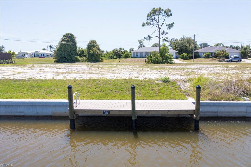 BRING ALL OFFERS! GULF ACCESS Lot with NEW 80' SEAWALL AND DOCK –MOTIVATED SELLER! One Bridge Out! Fantastic opportunity to own a .23-acre residential Gulf-access lot in Northwest Cape Coral. This CLEARED LOT features 80 feet of BRAND NEW SEAWALL, a PRIVATE DOCK, and desirable REAR EASTERN EXPOSURE—perfect for enjoying morning sunrises and shaded afternoons. Located on a wide canal with Gulf access via Matlacha Pass and just one bridge to pass under, this property offers easy boating to Matlacha Pass, Sanibel, Charlotte Harbor, St. James City, Sanibel Island, and the Gulf of Mexico. Ideal for boaters, anglers, or anyone dreaming of the waterfront lifestyle. Surrounded by beautiful new construction homes in a rapidly growing area, this lot is ready for you to build your custom dream home. Seawall and dock already in place—start enjoying waterfront living right away. Home next door available for purchase. MLS#225047746
