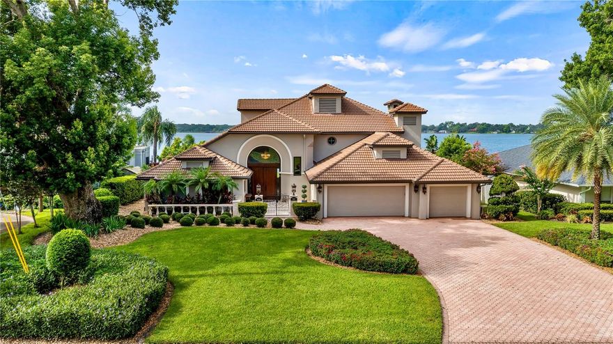Luxurious lakefront living on Butler Chain of Lakes. Discover unparalleled luxury and breathtaking views at Maywood Manor, a prestigious lakefront estate on Lake Down in Windermere's desired Butler Chain of Lakes. At 9626 Maywood Drive, Windermere, Florida 34786, this home offers a blend of sophisticated elegance and modern comfort. Key features: include prime lakefront location. Enjoy exclusive access to Lake Down and the entire Butler Chain of Lakes, with a private dock, boat house and boat lift, ideal for water enthusiasts. Stunning lake views. Lounge on the expansive travertine deck surrounding the heated spa, ideal for relaxing while enjoying panoramic firework displays and stunning sunsets. Renovated splendor. Completely renovated in 2011, this home showcases modern amenities and high-end finishes. Spacious interior. On an oversized home site, the residence features an open floor plan with cathedral ceilings and impact glass thermal windows, offering abundant natural light and breathtaking lake views. Outdoor entertaining. Entertain effortlessly with an outdoor kitchen, gazebo and screened lanai areas, providing ideal spaces for alfresco dining and relaxation. Additional features include a generator for peace of mind, a convenient in-law suite on the first floor, a new elevator added in 2020 and no HOA restrictions. Convenient amenities. Enjoy the comfort of lanai screens, an open floor plan conducive to modern living and a gourmet kitchen ideal for culinary pursuits. Recent upgrades such as the roof was replaced in 2018, ensuring long-term durability and peace of mind. Additionally, the air-conditioning units have been recently replaced for enhanced comfort and efficiency. This home comes furnished, offering luxury living ready for immediate enjoyment. Furnishings included at no additional cost to the buyers. *Please note personal touch as some artwork and personal items will not convey with the home purchase. Extensive entertainment. The home features 11 televisions throughout for your viewing pleasure. Spacious layout boasts five bedrooms and 4.5 baths, spread across 4,410 air-conditioned square feet, with a three-car garage providing ample space for vehicles and storage. Location benefits. Embrace the charm of Windermere with its scenic landscapes, top-rated schools and a vibrant community atmosphere. This exceptional lakefront retreat offers a rare opportunity to own a piece of paradise on the Butler Chain of Lakes. Schedule your private tour of Maywood Manor today to experience luxury living at its finest.