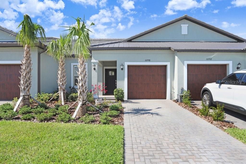 Built in 2024, this upgraded 2 bed / 2 bath Sunrise II Villa by Lennar is located in the highly sought-after 55+ gated section of Mirada. The single-story open-concept layout features crown molding in the living room, kitchen, and primary bedroom, beautiful quartz countertops in the kitchen and bathrooms, Low-E double pane windows and added cabinetry in the laundry room for extra storage. The home is situated perfectly to the sun and stays cool in the summers and warm in the winters, while the screened-in back patio offers full shade from sunrise to sunset—perfect for year-round outdoor living. Not to mention the peacefulness of the back porch as this home does not back up to a main road. In less than a five minute walk you can enjoy the resort-style amenities just around the corner, including pickleball, tennis, bocce ball, heated pool, fitness center, bar & grill, dog parks, and more! Golf cart access makes it easy to reach the 15-acre Crystal Lagoon with resident-only events and entertainment. Reliable power and ultra-fast Wi-Fi remained uninterrupted through the 2024 hurricane season. Located within an hour to Tampa Int’l Airport and downtown Tampa, 20 minutes to the outlets and The Grove, you will have easy access to all that Tampa has to offer!
Just move in and enjoy—no punch list, no waiting.