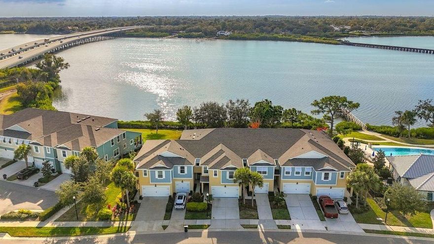 Welcome to 2005 Palm Key Avenue, a standout builder model waterfront townhome offering 4 bedrooms, 3 full bathrooms, and a 2-car garage in the highly desirable, gated Bayside Terrace community. This home delivers the ultimate “lock-and-leave” lifestyle with an HOA that covers cable, internet, water, trash, roof replacement, exterior maintenance, landscaping, and secure gated entry—making electricity the only separate utility expense.
One of the most impressive features of this home is its rare oversized waterfront setting. Natural light pours into the home, and the scenery becomes part of the everyday experience—enjoying beautiful bay and conservation views from the kitchen, dining area, living space, and the owner’s suite. The interior feels open and inviting thanks to soaring ceilings and a spacious, flowing floor plan designed for both comfort and entertaining.
At the heart of the home is the upgraded kitchen, thoughtfully designed with an oversized island with seating, a stylish built-in beverage/coffee bar with glass-front cabinetry, and a large walk-in pantry—perfect for hosting, meal prep, and staying organized.
Upstairs, the waterfront primary suite offers a peaceful escape with tranquil views and a spa-like bathroom featuring a soaking tub, separate shower, dual sinks, and a fully customized walk-in closet with built-ins. Two additional bedrooms are located upstairs along with a generously sized bonus room that can easily function as a media lounge, playroom, home gym, or game room. You’ll also love the convenience of the oversized upstairs laundry room, complete with custom built-ins and glass-front cabinetry, located just steps from the primary suite. Downstairs, an additional bedroom provides flexibility and can easily serve as a guest room or dedicated home office.
Outside, relax and unwind in the screened lanai, where waterfront views set the stage for quiet mornings and stunning sunsets. Bayside Terrace residents enjoy an impressive lineup of resort-style amenities, including an infinity-edge pool overlooking Old Tampa Bay, fitness center, grilling stations, fire pit, kayak launch and storage, and a waterfront pier ideal for fishing or simply taking in the scenery.
Perfectly positioned in the heart of Tampa Bay, this home is just minutes from downtown Oldsmar, about 10 minutes to Safety Harbor, 20 minutes to Honeymoon Island and Dunedin, 25 minutes to Tampa International Airport, and approximately 30 minutes to Clearwater Beach.
This is a rare opportunity to own a waterfront townhome that combines luxury, location, and low-maintenance living—and as an added bonus, the current flood insurance policy may be transferable to the new owner.