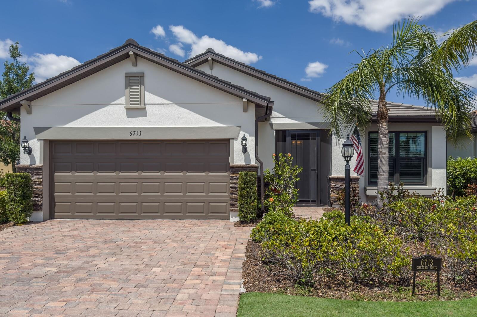 Welcome to 6713 Chester Trail, a beautifully appointed Martin Ray model nestled in the popular 55+ gated community of Del Webb at Lakewood Ranch. Enjoy the Florida lifestyle and have complete peace of mind - you can be storm ready within 5 minutes - WHOLE HOUSE GENERATOR and SURGE PROTECTION, IMPACT WINDOWS, KEFLON SHADES on the patio that electrically roll down in seconds. This 1,964 sq ft single-family home offers 2 bedrooms, 2 bathrooms, and a versatile den, all designed with comfort and style in mind. You are welcomed inside through a complete screened-in front porch lanai. The home's open-concept layout features include built-ins and custom accent walls, a gourmet kitchen equipped with stainless steel gas appliances, stone countertops, a spacious island, and a walk-in pantry, perfect for culinary enthusiasts. Porcelain tile laid on the diagonal enhances the main living areas, while the den provides a flexible space for a home office or guest room. Brand new flooring in all the bedrooms, no carpet. Step outside to a large, screened lanai that overlooks a serene water view, creating an ideal setting for relaxation or entertaining guests. The property also includes a 2-car garage with additional space for a golf cart, catering to the active lifestyle of the community. Residents of Del Webb at Lakewood Ranch enjoy access to a wealth of amenities, including a resort-style pool, tennis and pickleball courts, bocce ball, a state-of-the-art fitness center, and a full-service restaurant. The community's vibrant social scene is supported by a full-time activities director, ensuring a dynamic and engaging lifestyle. Experience the perfect blend of luxury and leisure in this exceptional home.