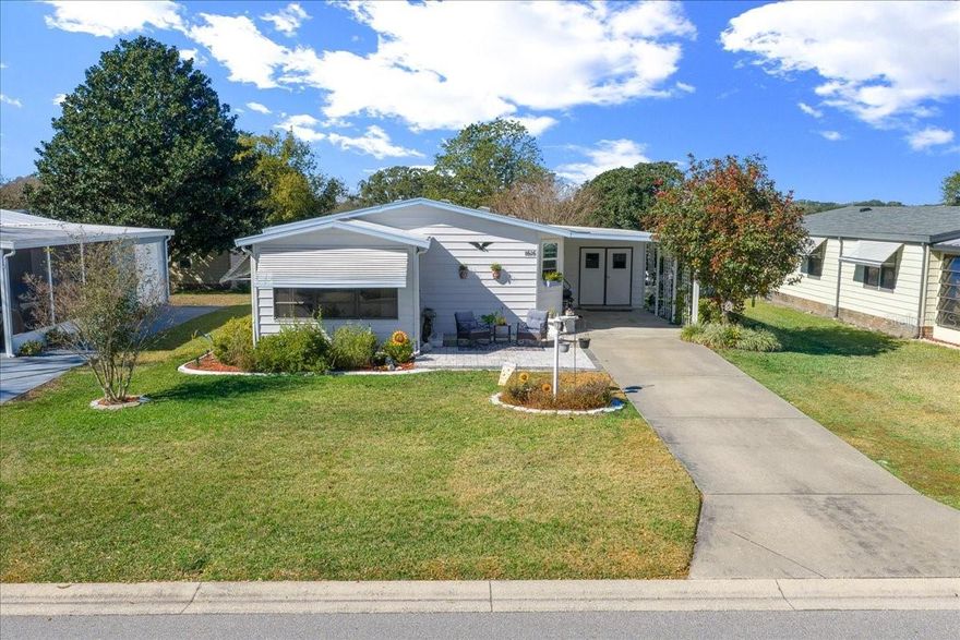 NO BOND! Affordable TURNKEY Opportunity in the sought-after Orange Blossom Community — MOVE-IN READY and full of charm!

Located just a short distance from Hilltop Golf Course, Pool & Restaurant, this delightful 2 Bedroom, 2 Bath home offers a warm, welcoming feel throughout and NO CARPET anywhere for easy maintenance and a clean, modern look.

Enjoy relaxing on the charming front paver patio, the perfect spot for morning coffee or evening unwinding. The enclosed front porch adds additional living space and opens to the spacious 15' x 14' patio, ideal for entertaining or enjoying Florida’s beautiful weather.

Inside, the large eat-in kitchen flows seamlessly into the living room, creating an open and comfortable layout. The nicely furnished guest bedroom is inviting and move-in ready, while the primary bedroom features a walk-in shower and a comfortable retreat at the end of the day.

Recent updates include new flooring, new stove & microwave, double-pane vinyl windows (2017), NEW HVAC (2023), Roof (2011), and exterior paint (2022).

The exterior offers a large carport and an outside utility room complete with washer, dryer, and hot water heater.

A TURNKEY, affordable, and charming home in a prime location — perfect as a full-time residence, seasonal retreat, or investment opportunity!