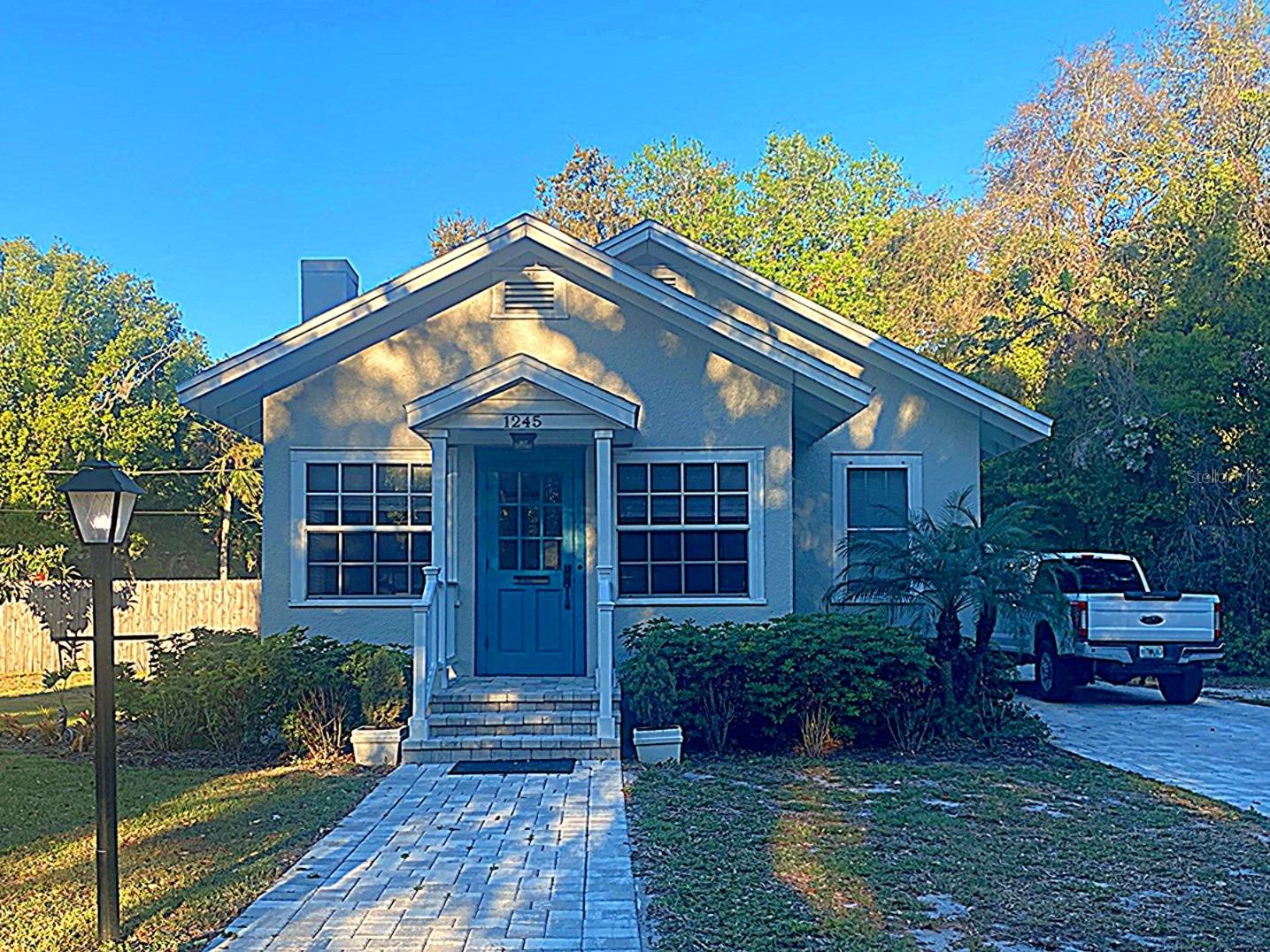 Charming historic pool home in downtown Mount Dora has 2 bedroom, 1.5 baths and sits on an oversized fenced corner lot. Delightful vintage charm abounds with wood floors, wood moldings, period hardware, built-ins and a non-working but lovely fireplace. Inviting, light filled home features an enclosed front porch (a great home office or craft room), living room, dining room, eat-in kitchen and interior laundry room. Kitchen has custom cabinets, stainless steel appliances, apron sink, granite counters, tile backsplash, pantry pull outs and island. Laundry room has tons of pantry storage, broom closet, custom cabinets and granite counters. Master bedroom has walk-in closet. Back screened porch overlooks fenced backyard which includes kidney shaped, salt water pool, covered deck area, brick paver sun pad (additional patio space) and landscaping. Rental includes 2 bedroom, 1.5 bath home, 1 car garage and pool but does not include back dirt driveway, back patio and upstairs apartment.