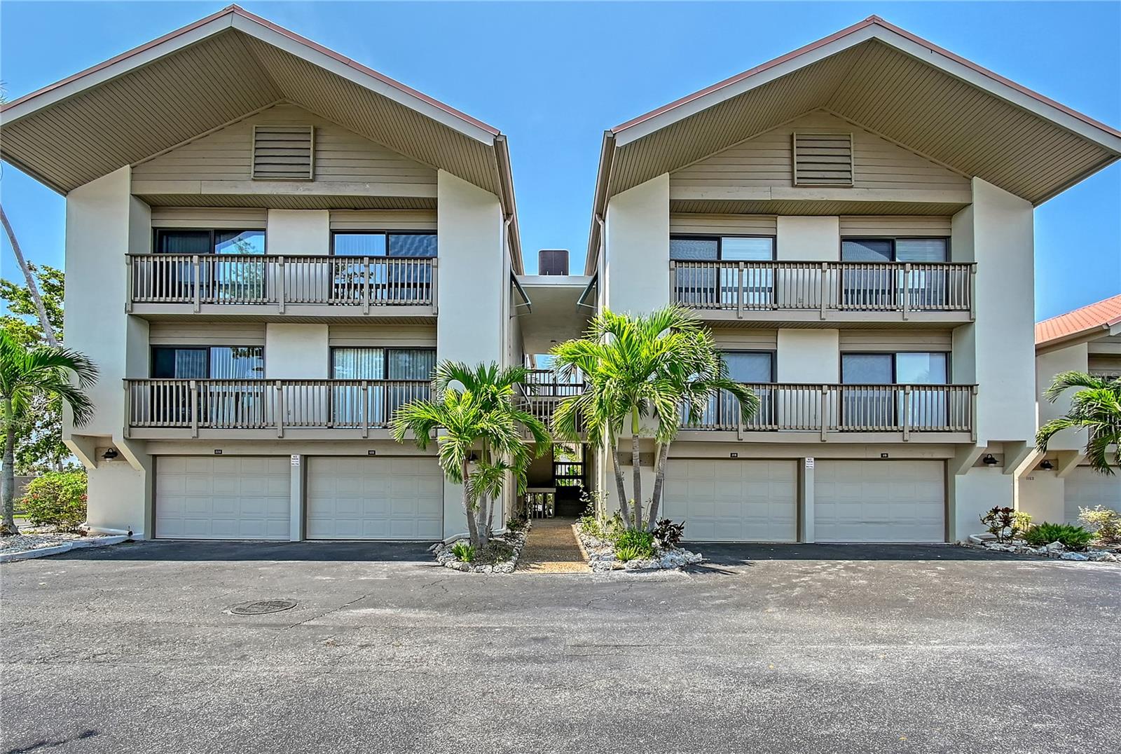 Enjoy this ultimate beach getaway and investment opportunity! This updated 2-bedroom 2 bath townhome is located directly across from Siesta Key beach and offers a generous split-bedroom and bi-level layout. Featuring high ceilings, a large light-filled eat-in kitchen, inside laundry, separate dining and living room areas and a spacious balcony overlooking the serene lake. The master bedroom suite also opens onto a balcony and includes an en-suite bathroom with ample closets and a dressing area. Our House at the Beach allows for weekly rentals, making for fantastic investment potential, or a perfect place to call home. New Hurricane Impact windows and sliding glass doors are being scheduled for installation at the Lake Houses. The central location on Siesta Key is unbeatable, and with your own garage, beach parking will never be a concern again. Simply load your beach cart and enjoy the breathtaking sunsets or catch the Siesta Breeze Bus to Siesta Village, South Siesta or Downtown Sarasota. Our House at the Beach is a well-maintained complex with a heated swimming pool, two tennis courts, pavilion, grilling area, and on-site rental management. Just minutes from Siesta Key Village where you can explore a variety of restaurants and shops. This unit is not only a perfect beach escape but also a smart investment opportunity.
